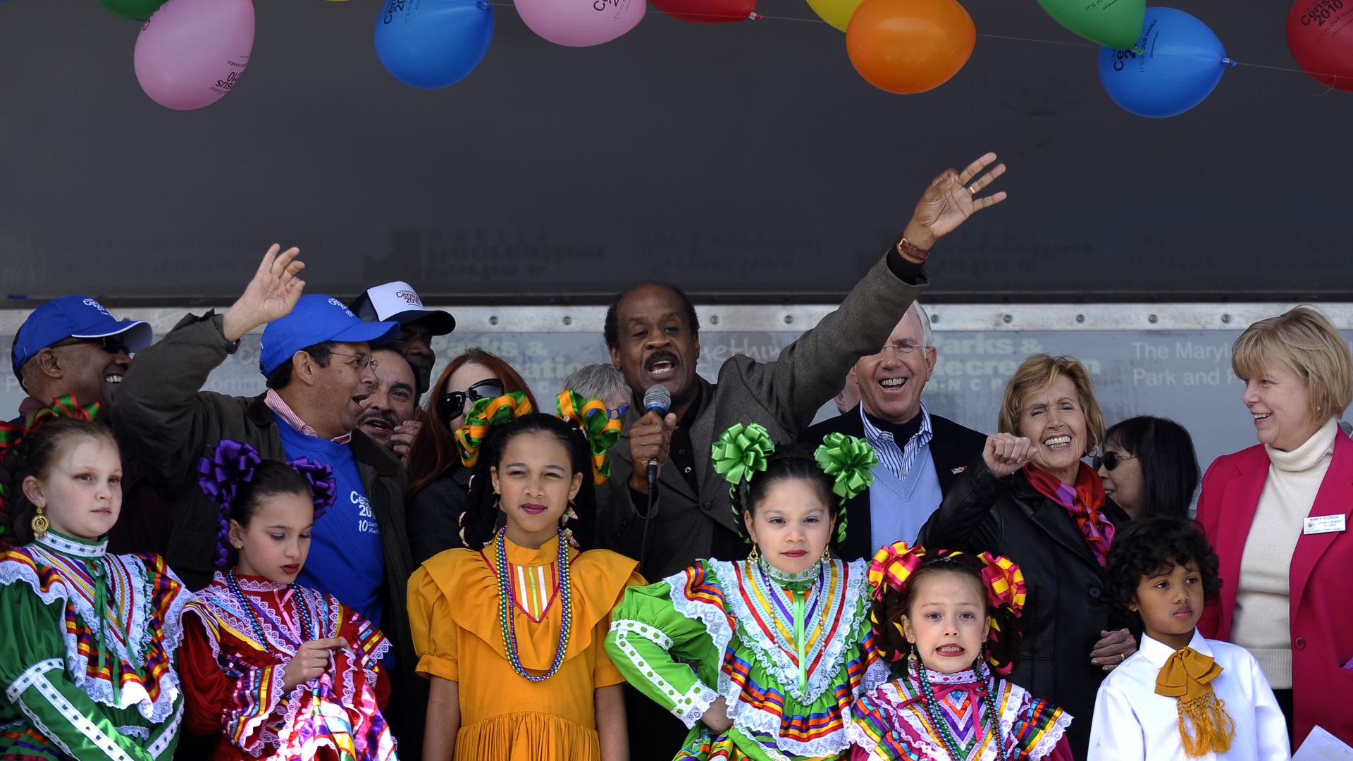 Montgomery County Executive Ike Leggett, center, encourages folks from the Latino community to fill out their Census paperwork during the "Stand Up and Be Counted" rally in Langley Park, Md.