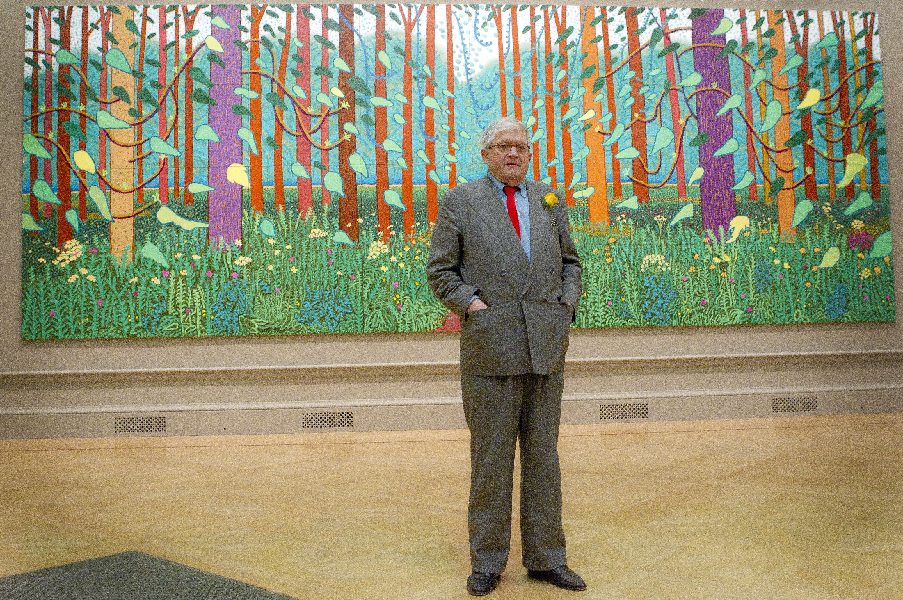 David Hockney in front of one of his paintings of the East Yorkshire landscape at London's Royal Academy of Arts in 2012. AP Photo/Joel Ryan