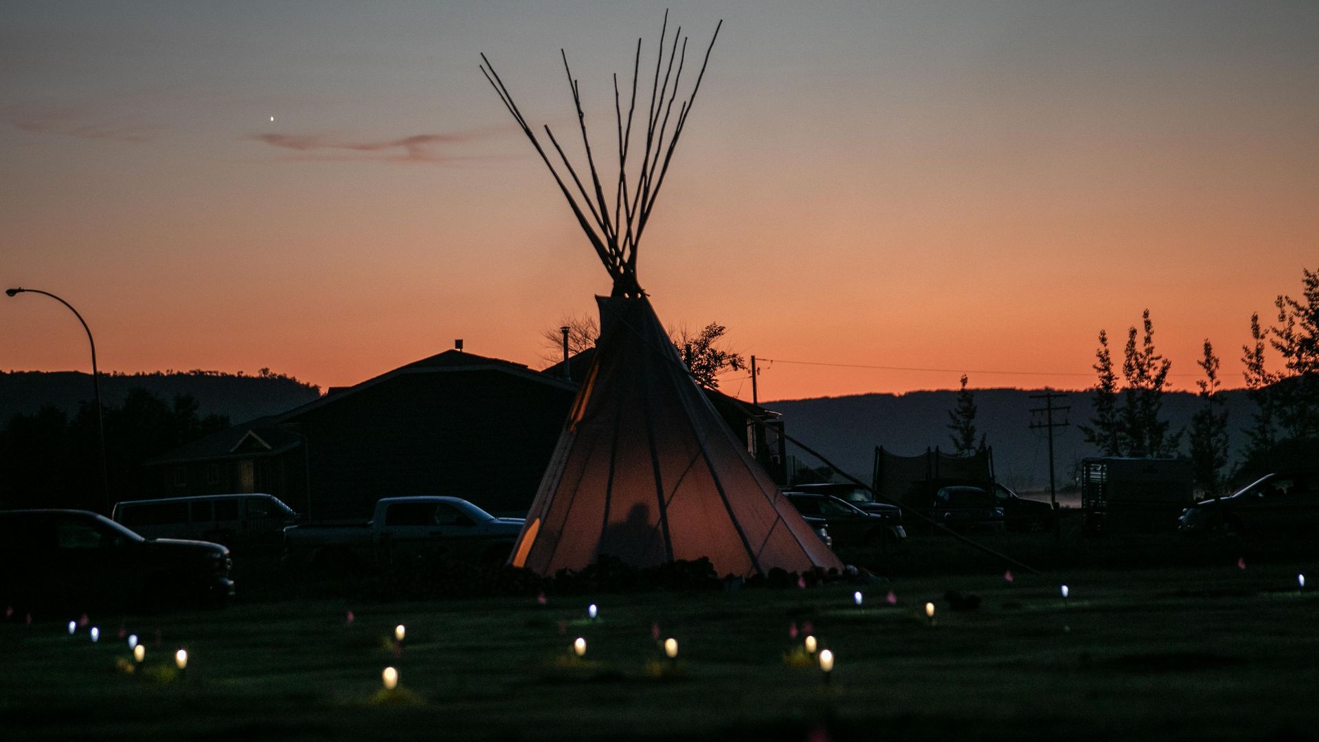 Solar lights and flags now mark the spots where 751 human remains were recently discovered in unmarked graves.