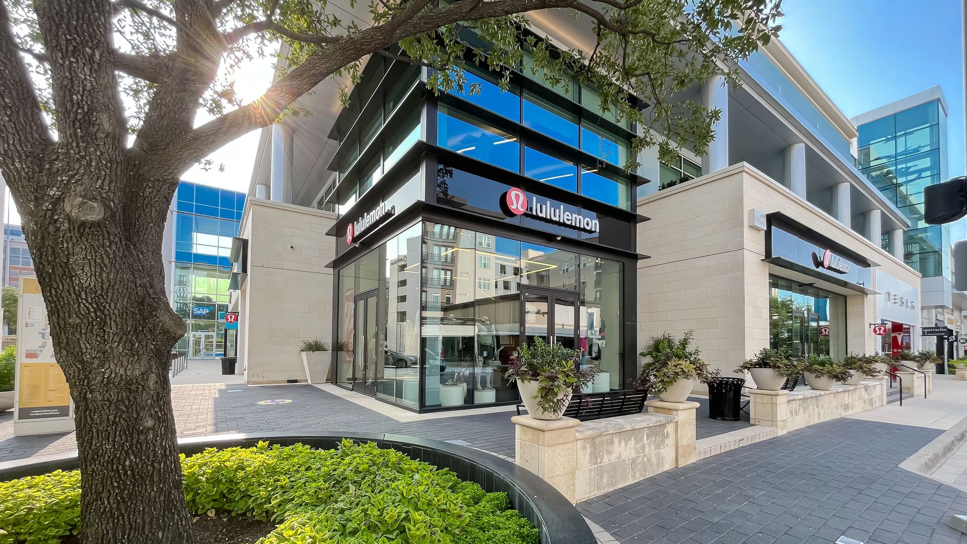 An outdoor shopping mall with a "Lululemon" sign in a storefront