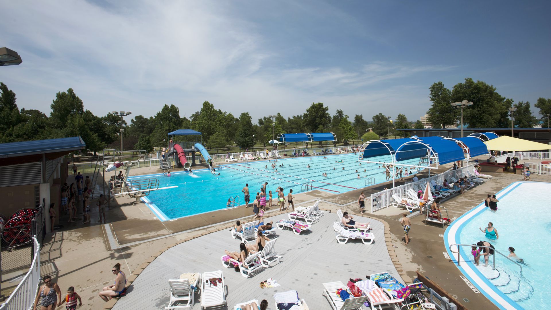 A crowd hang out at a local swimming pool