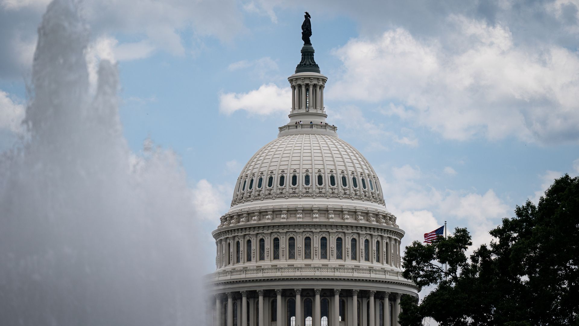 The U.S. Capitol dome with a fountain in the foreground