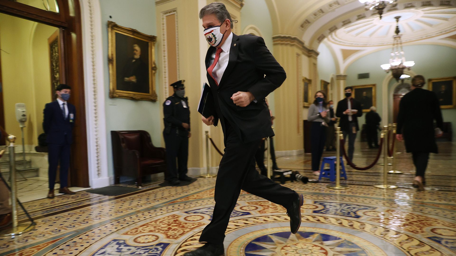 Joe Manchin is seen jogging into the Senate Chamber.