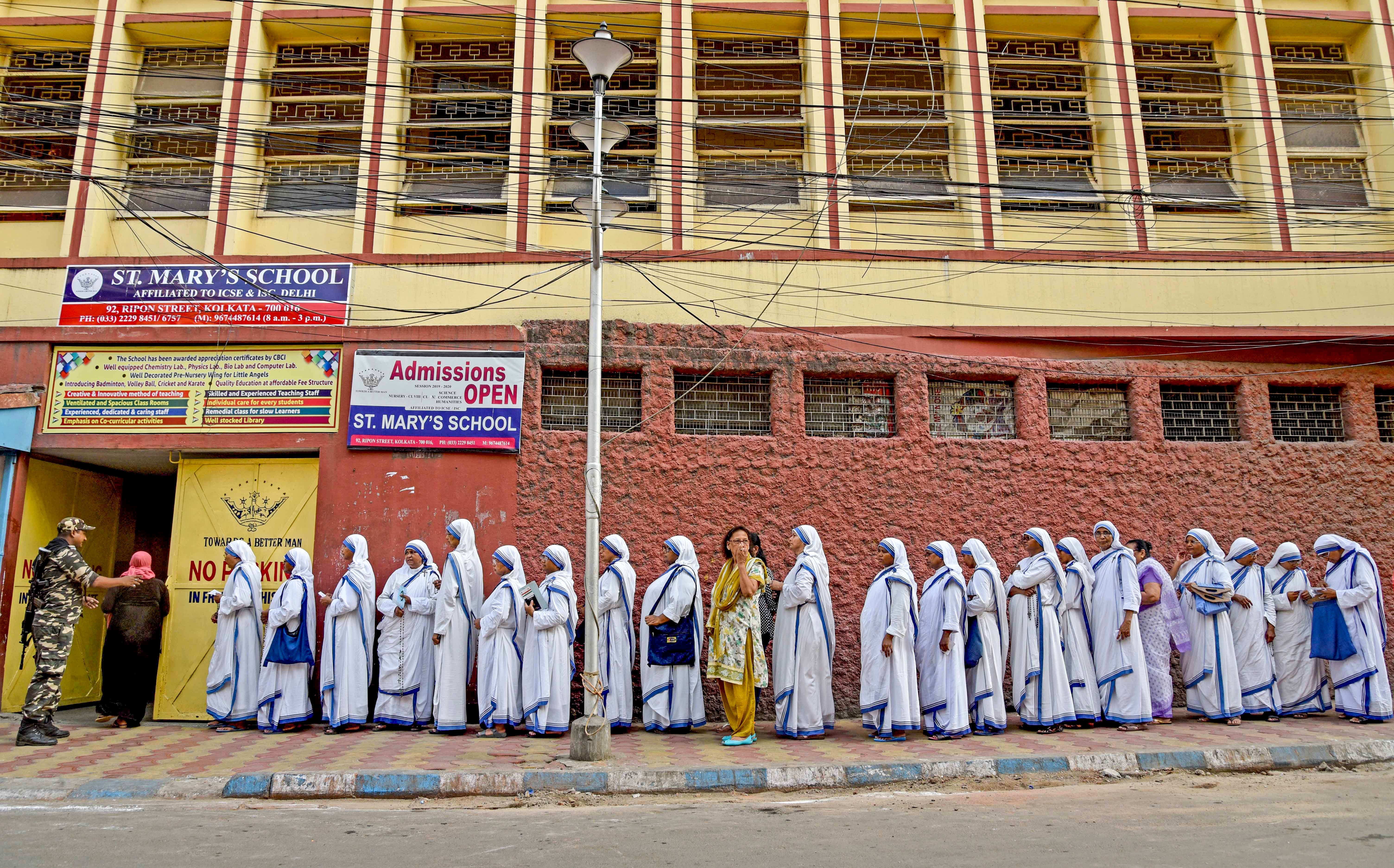Indian nuns from the Mother Teresa Missionaries of Charities queue to cast their votes.