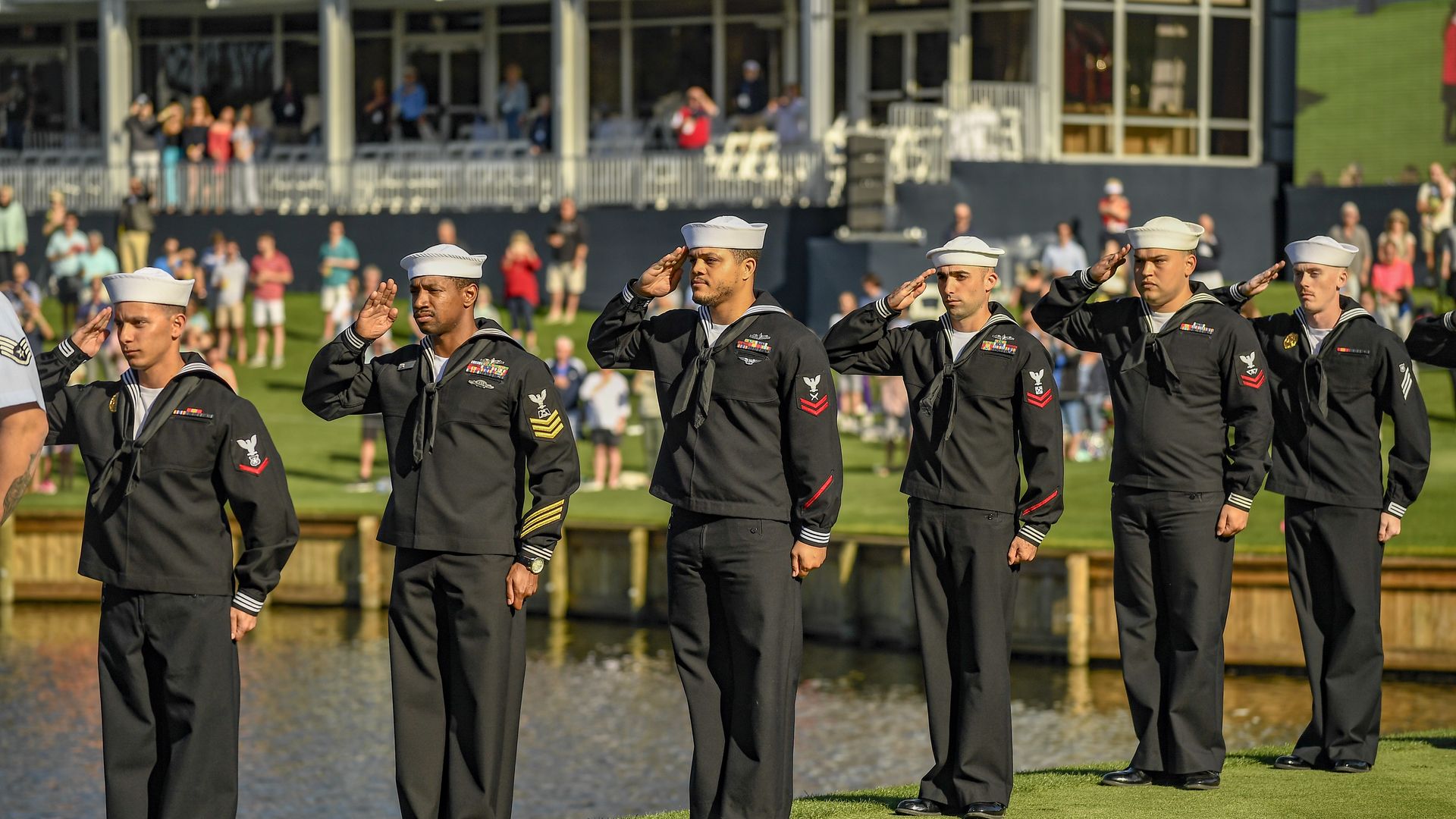 U.S. sailors saluting the flag