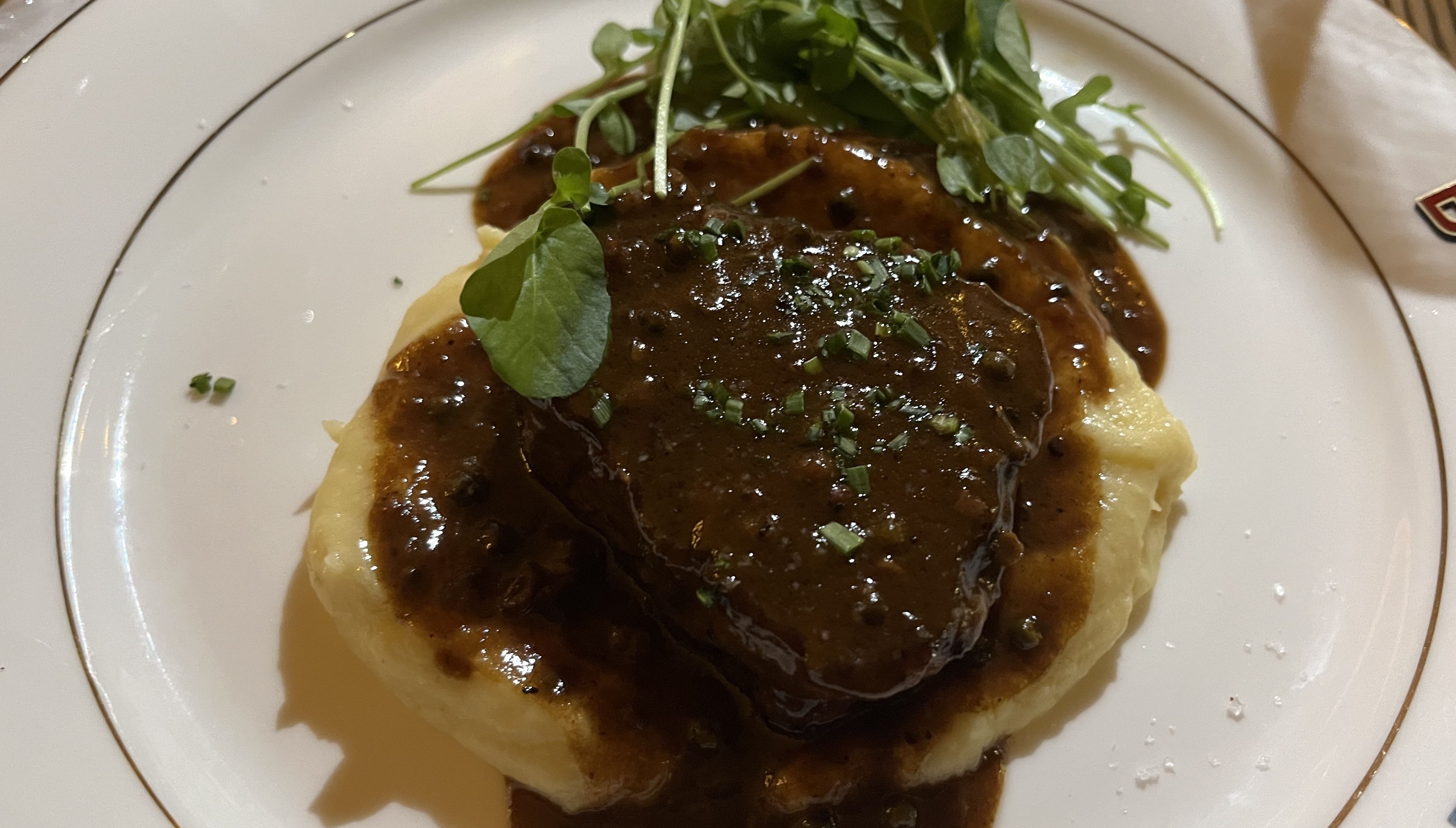 Photo of steak on top of mash potatoes 