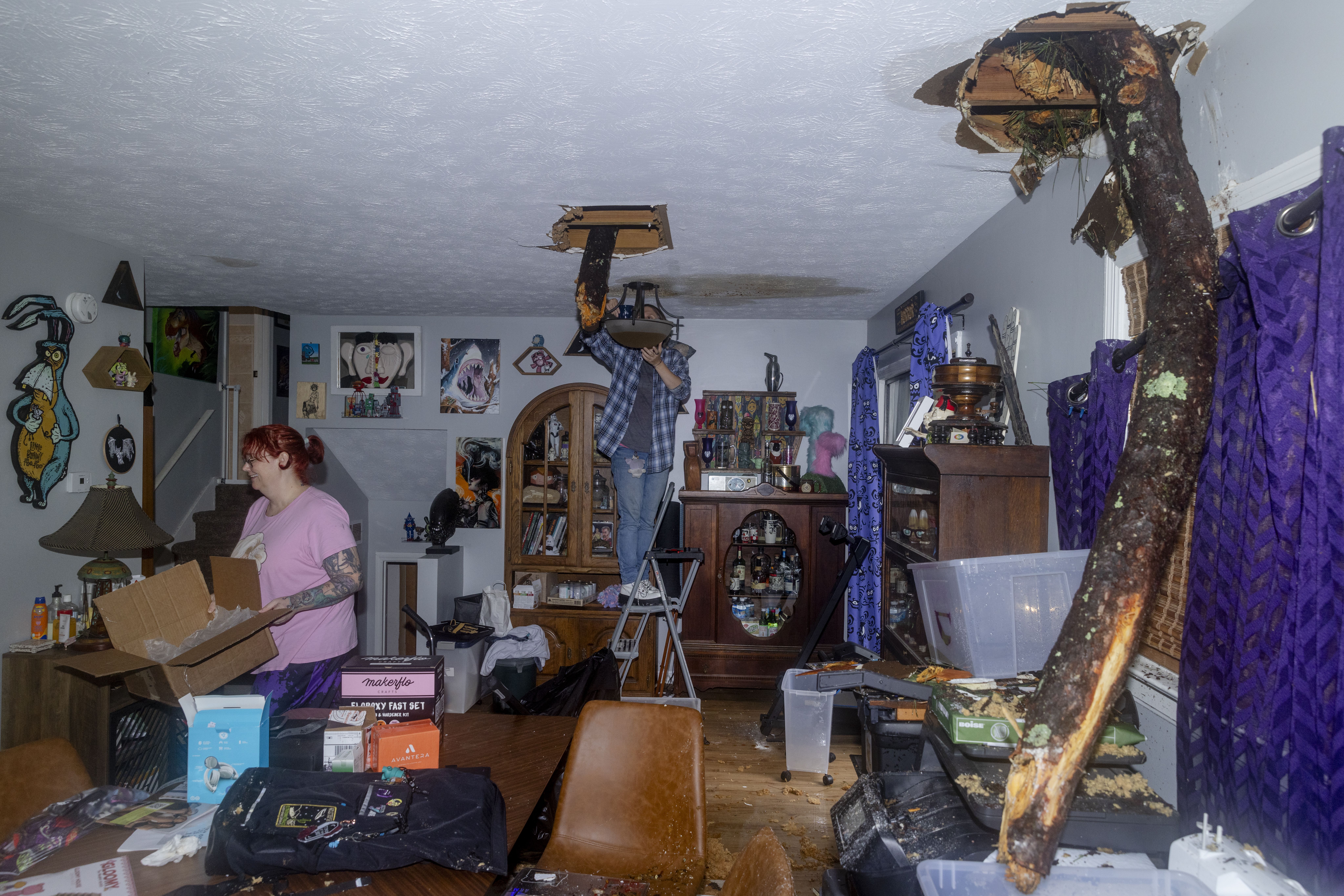 A tree protrudes from the ceiling of a home in Morrow, Ga after Tropical Storm Helene blew threw the area. 