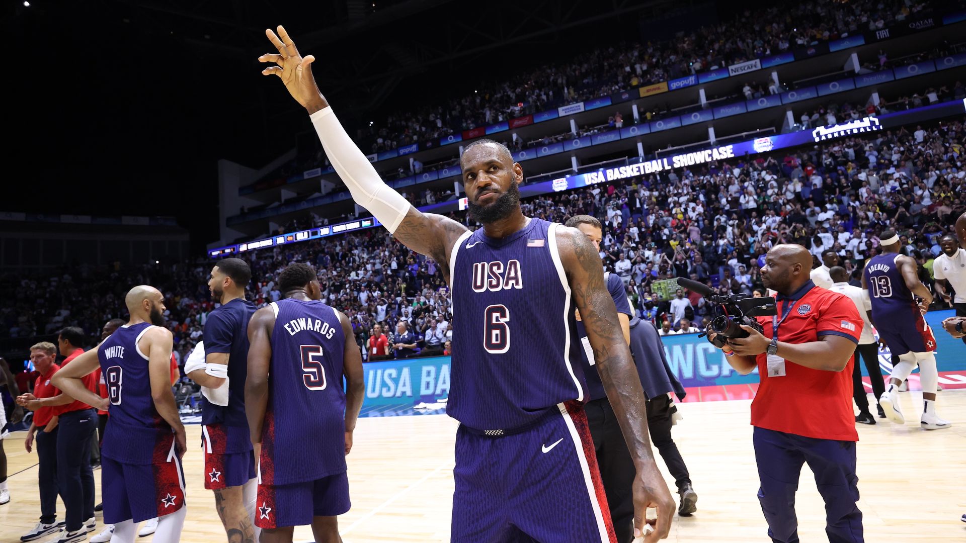 LeBron James waves to fans during a Team USA basketball game. 