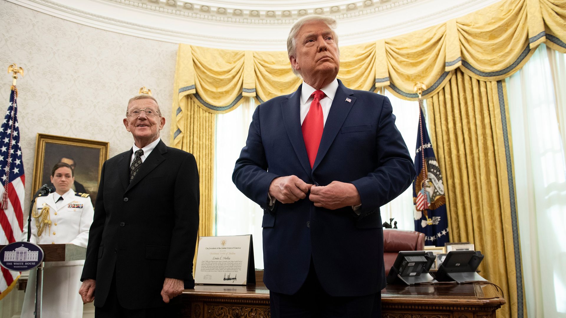 Photo of Donald Trump standing in the Oval Office next to Lou Holtz