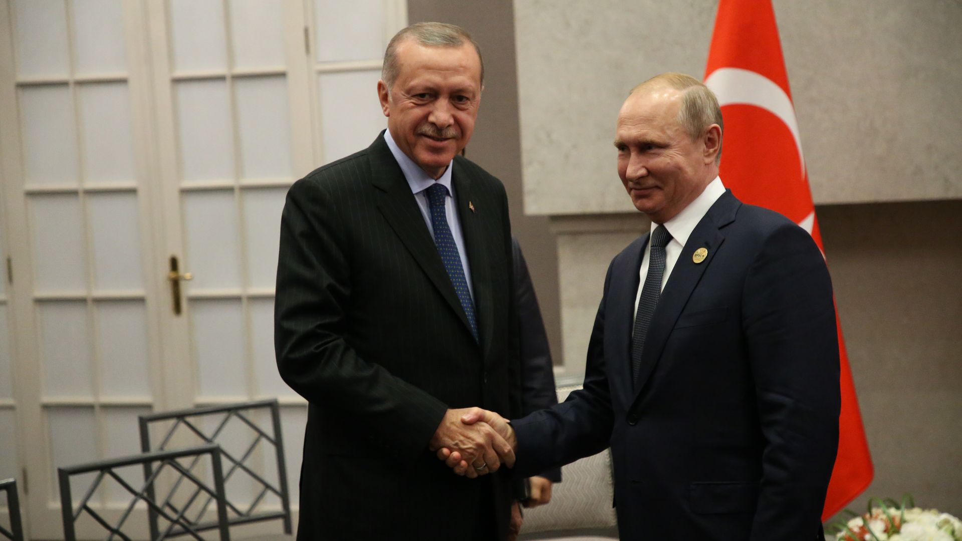 Turkish President Erdogan shaking hands with Vladimir Putin