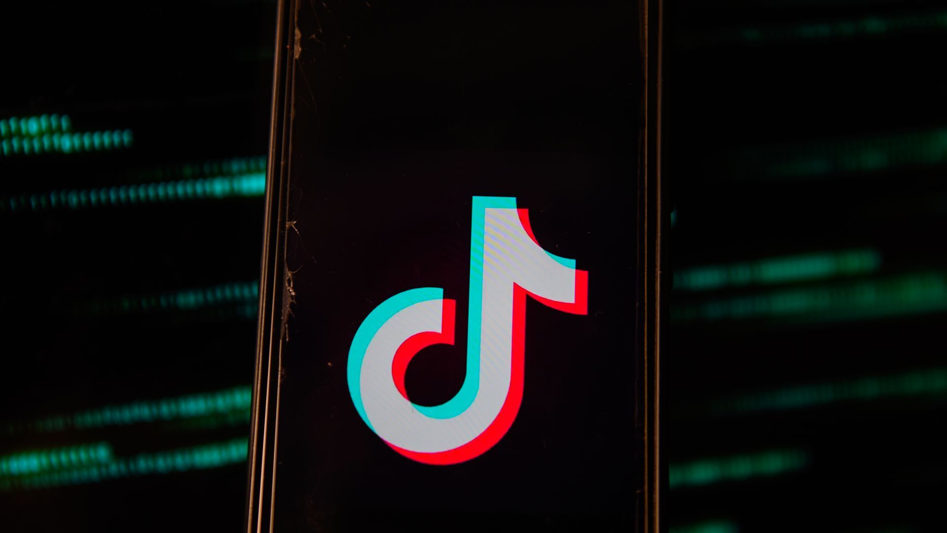 A photo illustration of the TikTok logo on a smartphone