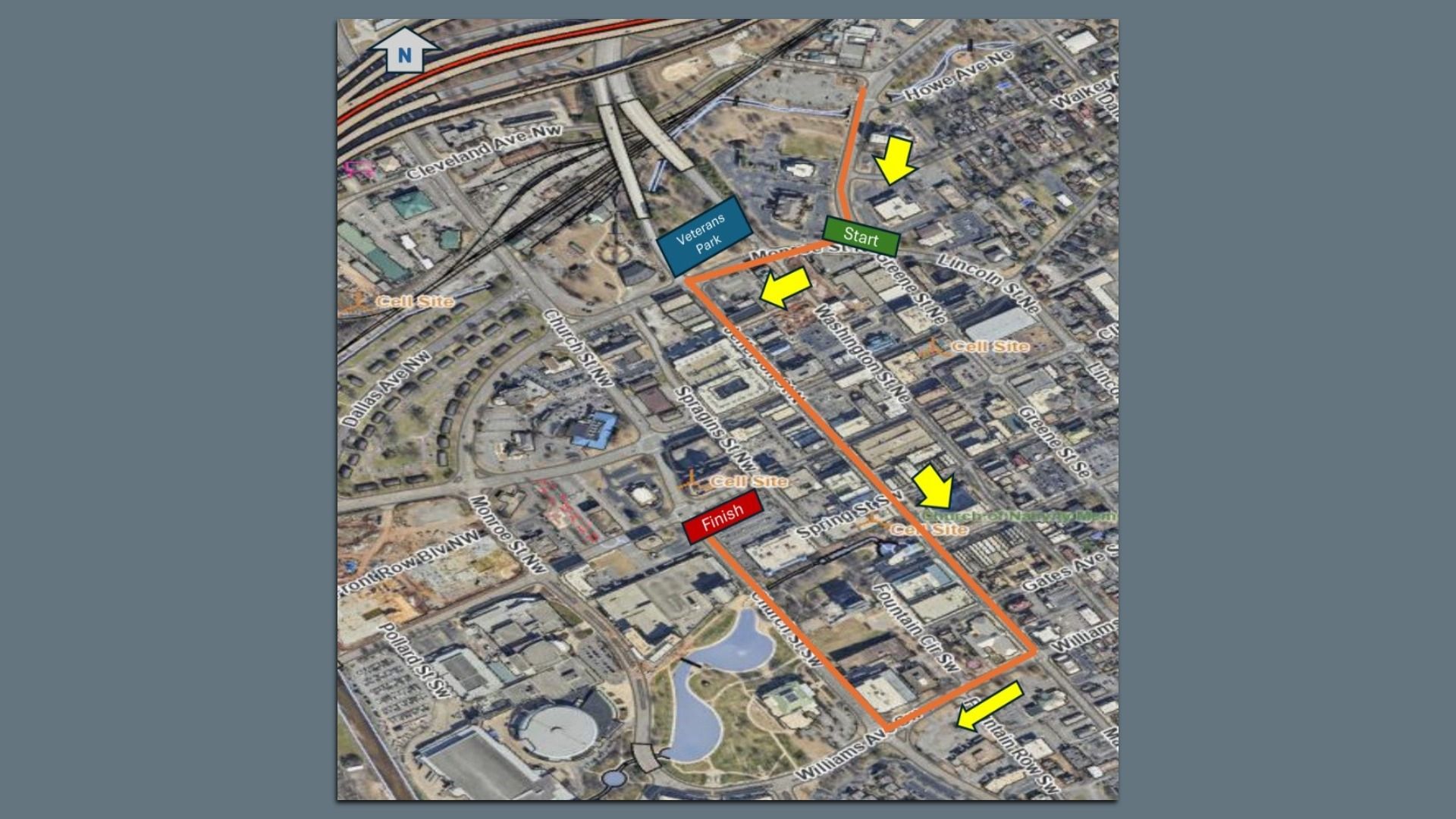 An aerial map of a race route in orange, starting at a green Start marker near Veterans Park, winding along city streets with two yellow arrows, ending at a red Finish marker.
