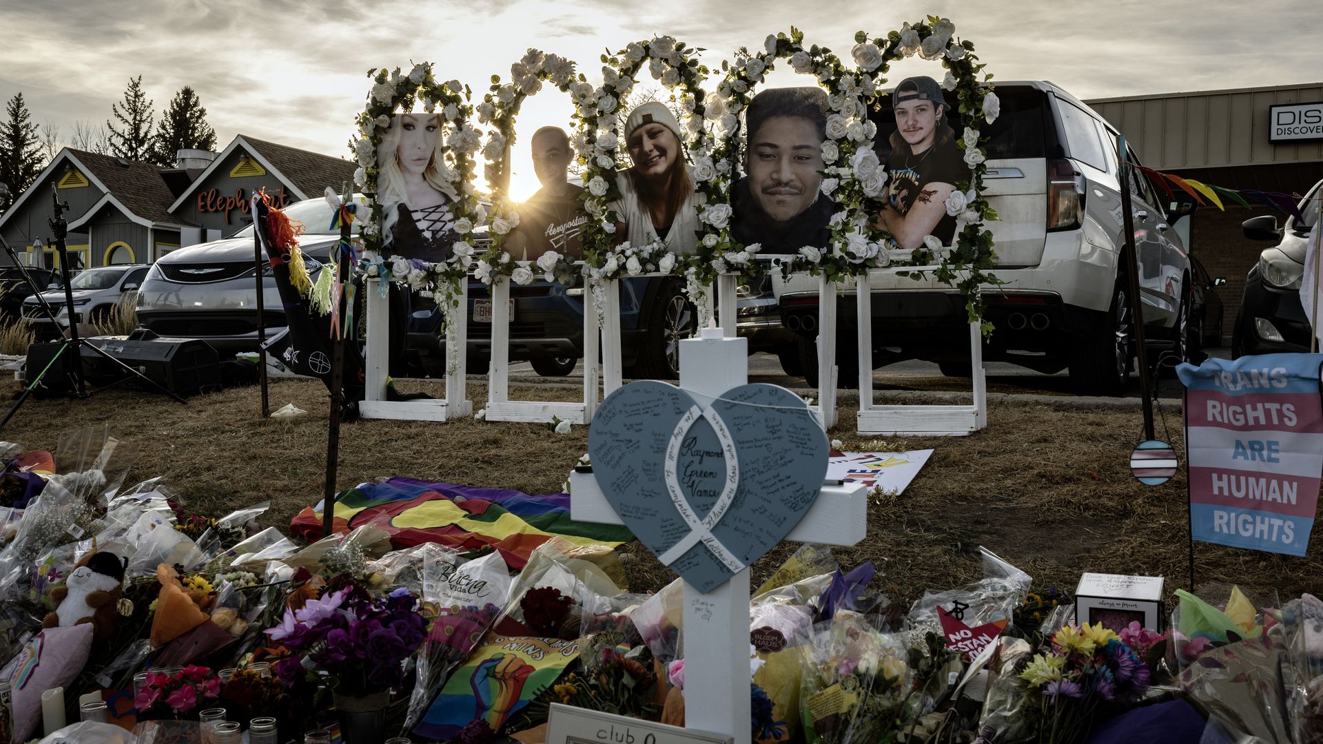 Photos of the shooting victims are displayed at a makeshift memorial outside of Club Q on November 22, 2022 in Colorado Springs, Colorado. A gunman opened fire inside the LGBTQ+ club on November 19th, killing 5 and injuring 25 others before being tackled and disarmed by a club patron. 