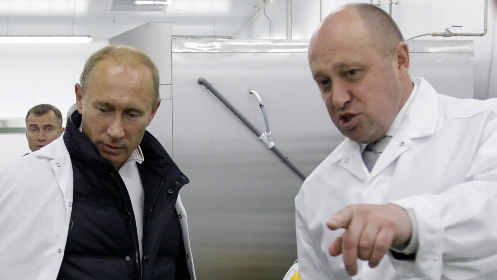 Businessman Yevgeny Prigozhin shows Russian Prime Minister Vladimir Putin his school lunch factory outside Saint Petersburg on September 20, 2010. 