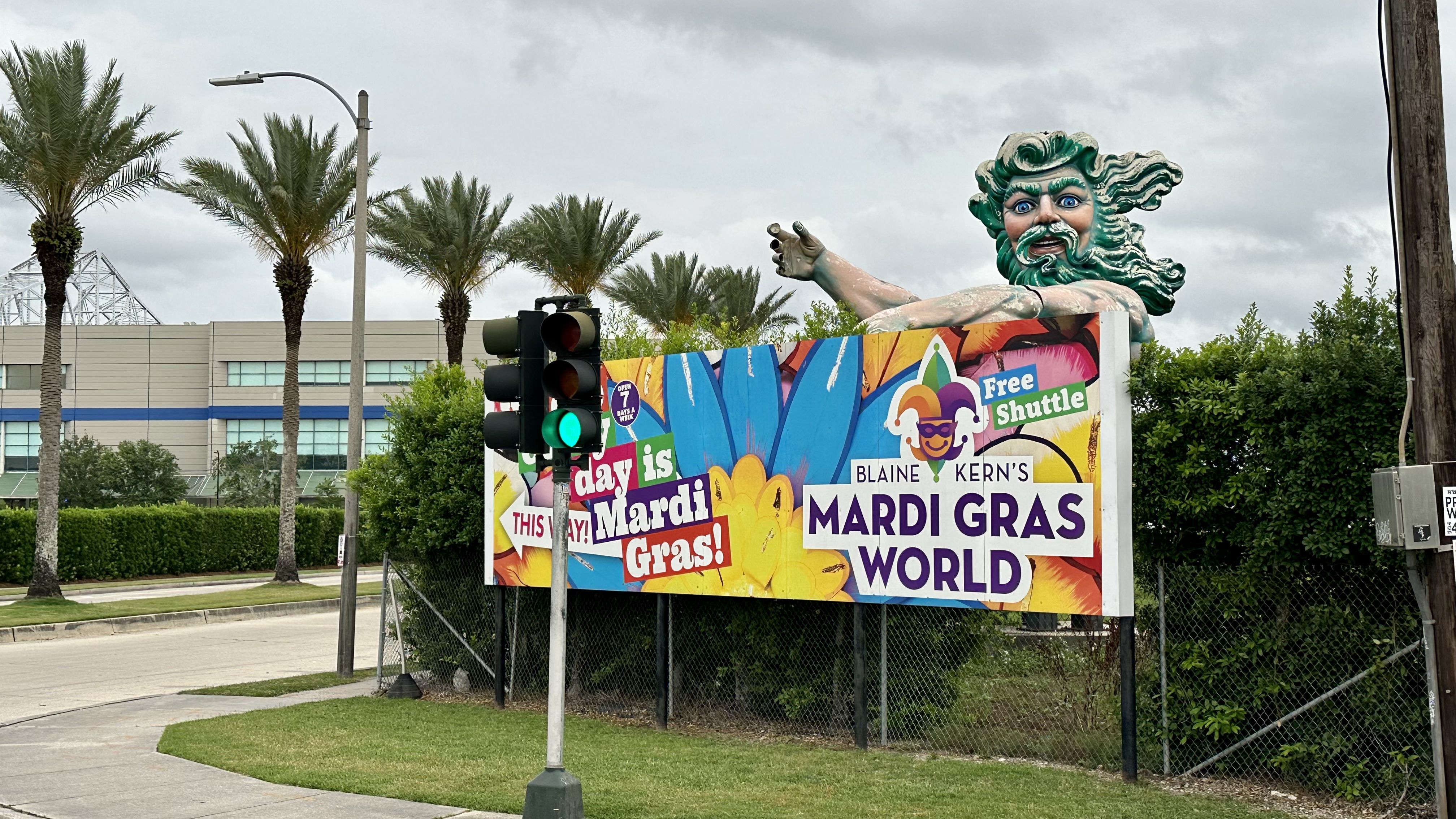 Photo shows Neptune's head above a Mardi Gras World sign.