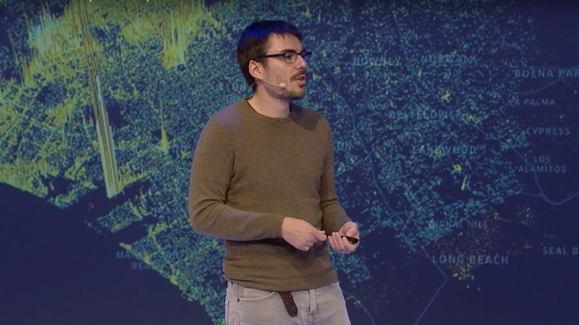 A photo of Nico Belmonte against a digital map