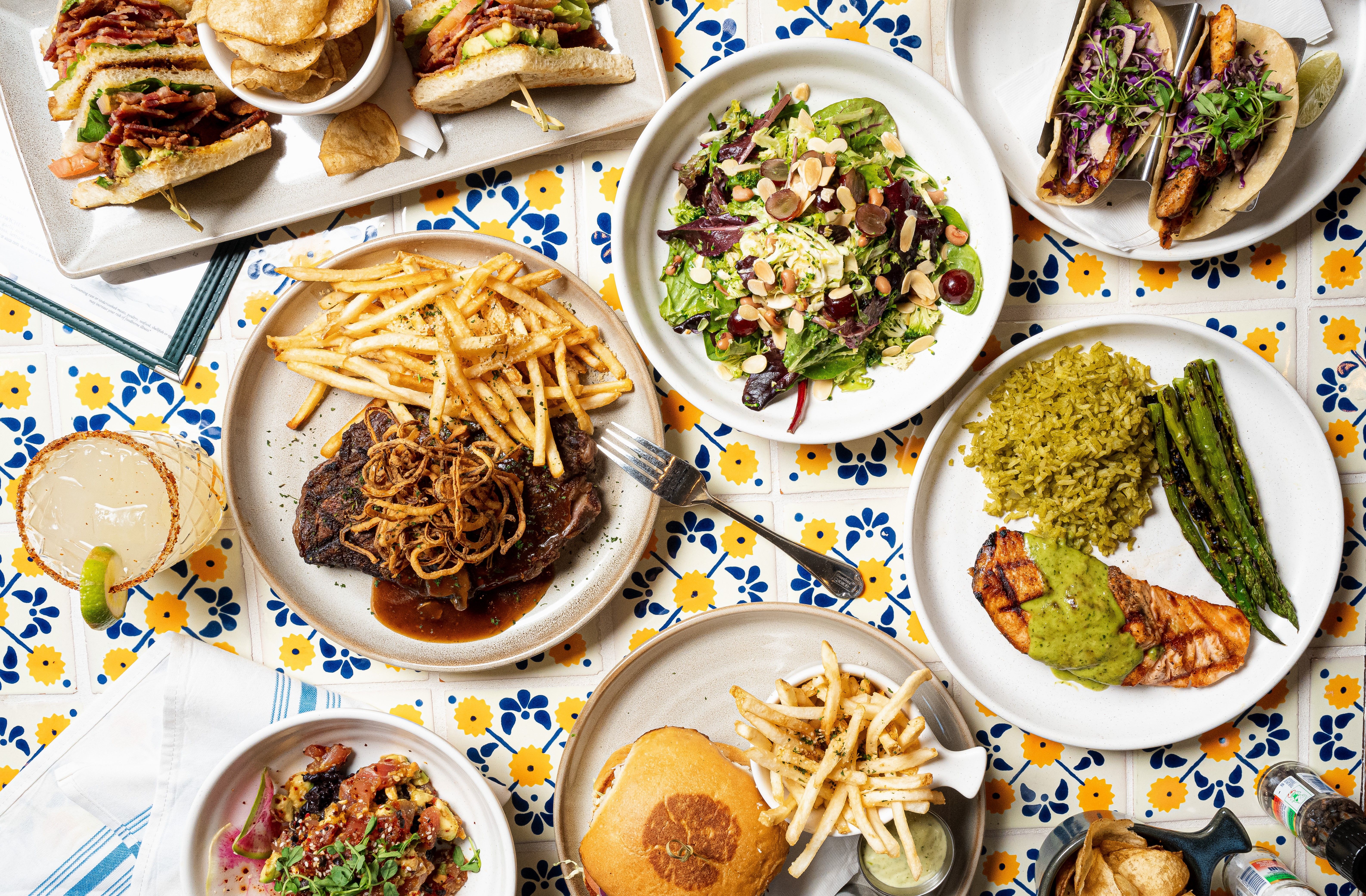 A spread of food on a tiled table. 