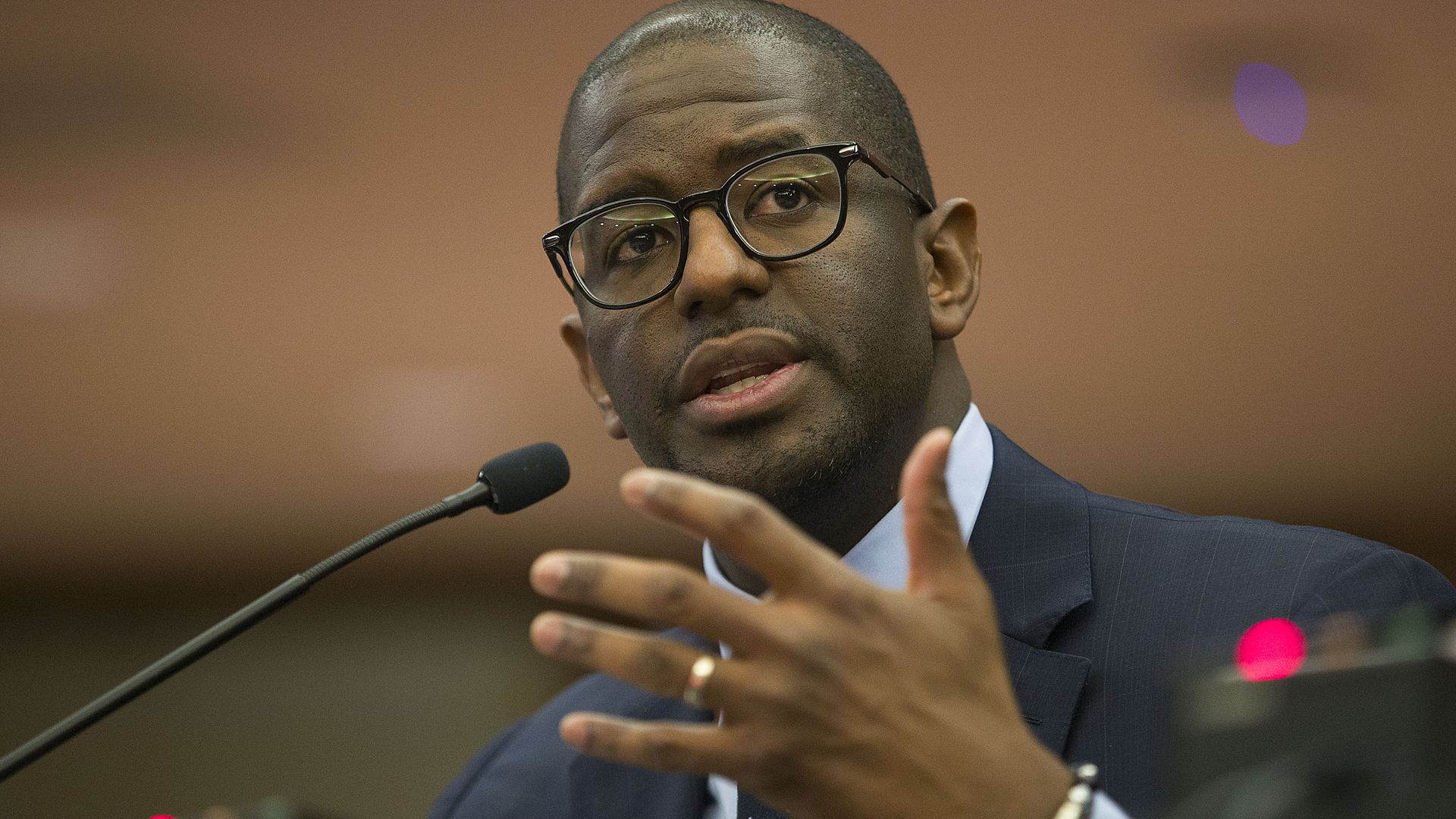 Gillum speaking into a microphone
