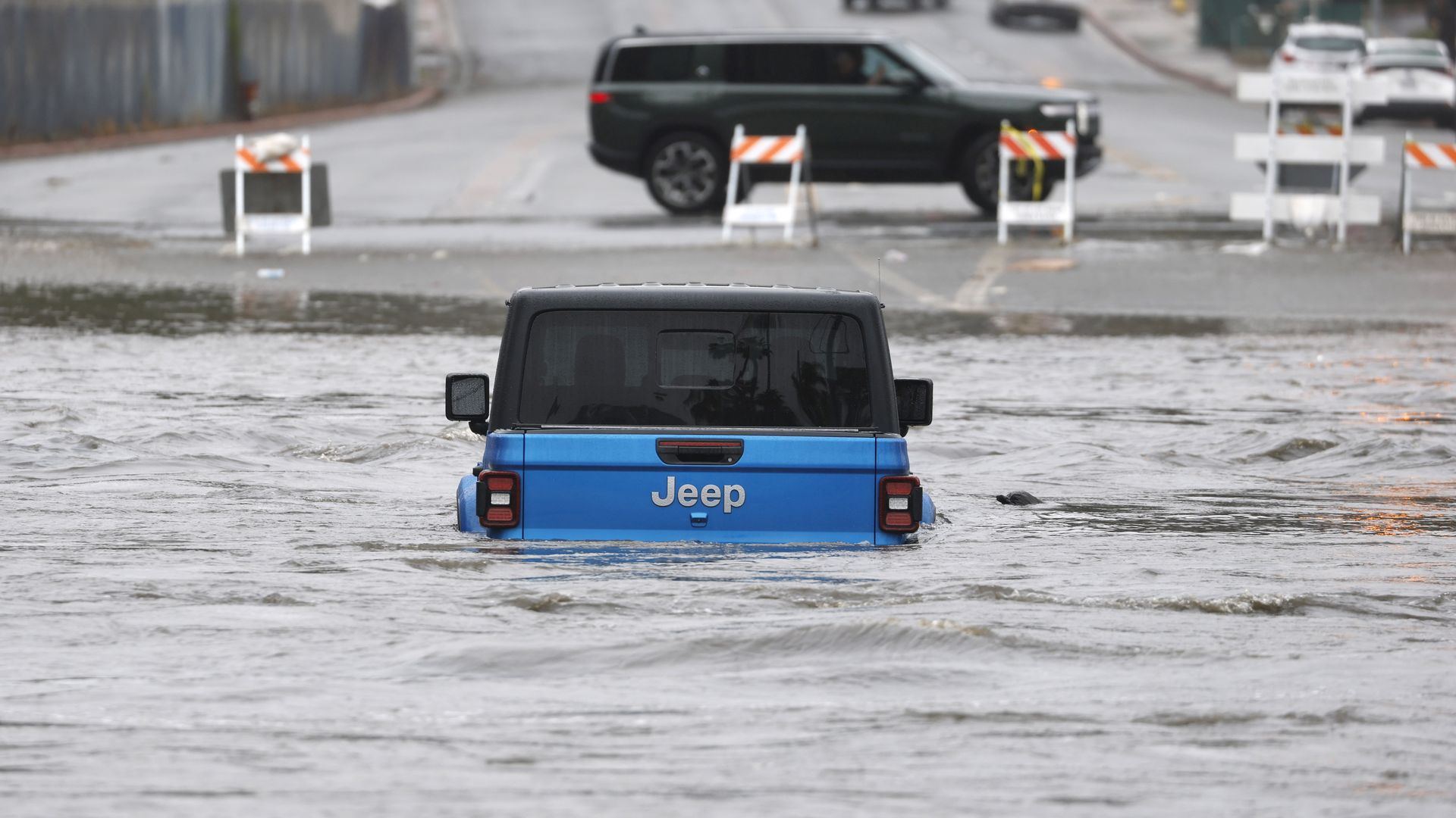 San Diego, CA - January 1: An adult and a child were rescued from a Jeep on Fashion Valley Road by the San Diego Lifeguard River Rescue Team after San Diego River overflowed and flooded areas in Mission Valley during a storm on January 1, 2026 in San Diego, CA. (Photo by K.C. Alfred / The San Diego 