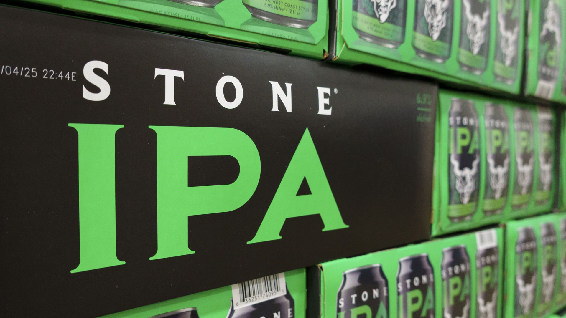 Stacked green and black cases of Stone IPA are displayed at a Costco Wholesale store. 