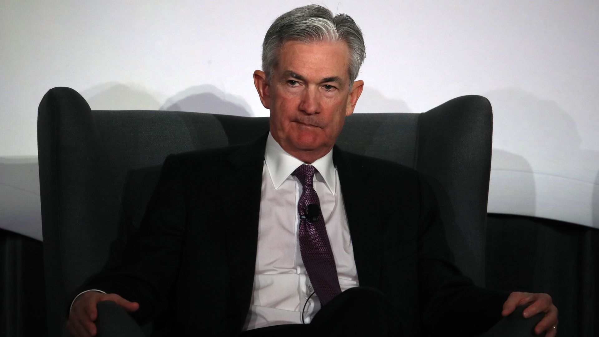 Chairman of the Federal Reserve Jerome Powell sitting in a chair