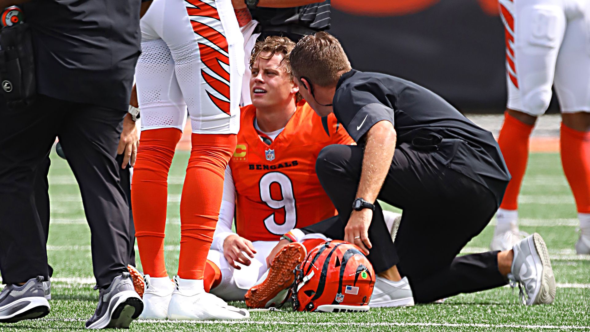 Cincinnati Bengals quarterback Joe Burrow sits on the field after sustaining an injury