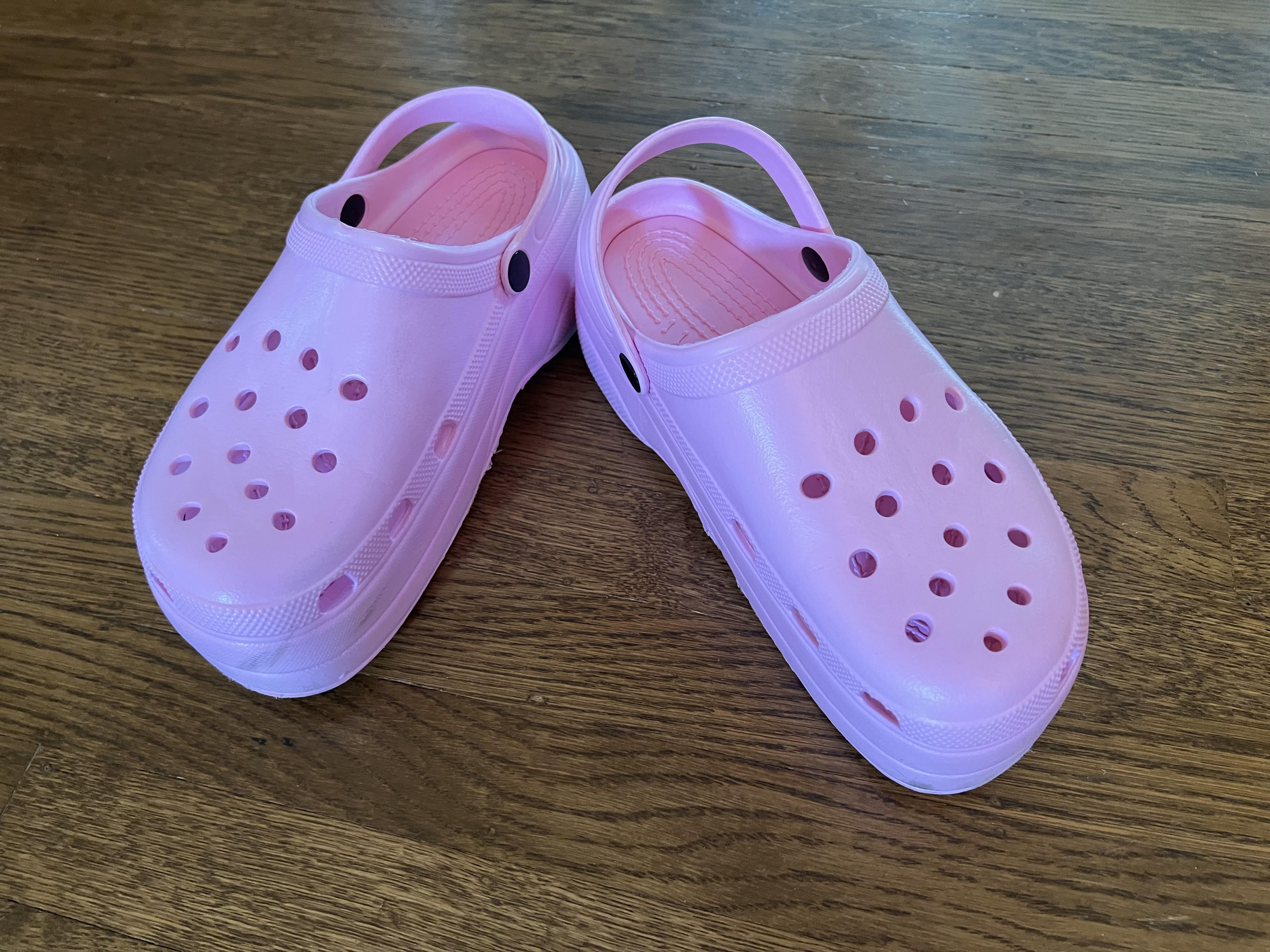 A pair of pink Crocs clogs.