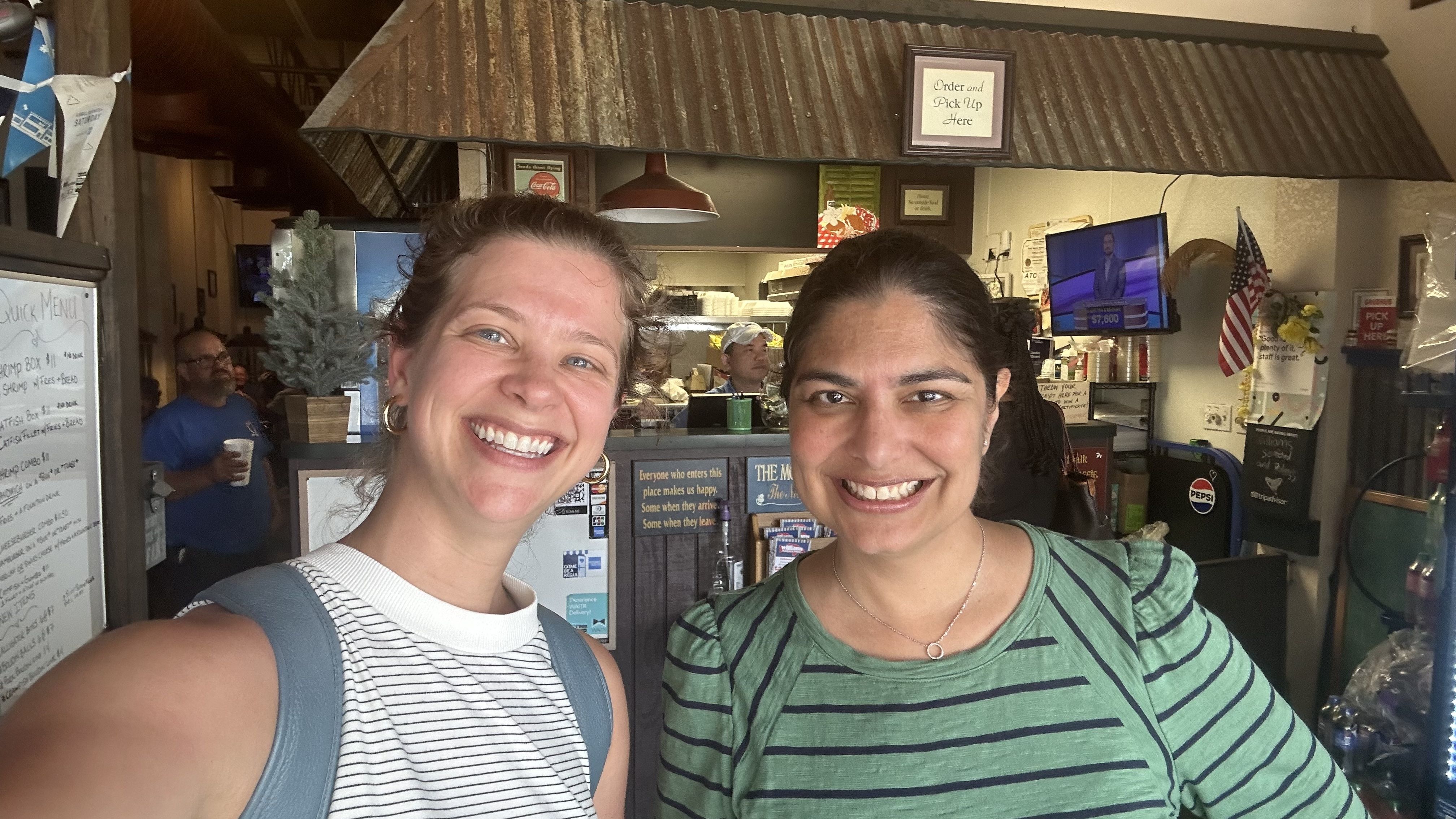 A selfie with Chelsea Brasted and Taslin Alfonzo while they stand near the ordering counter for Williams Seafood & Poboy.