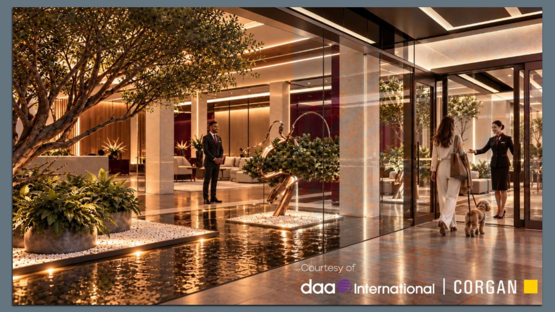 Luxurious hotel lobby with glass doors, warm lighting, and indoor trees; a suited man stands beside a sculptural fountain while two women, one with a dog, enter.