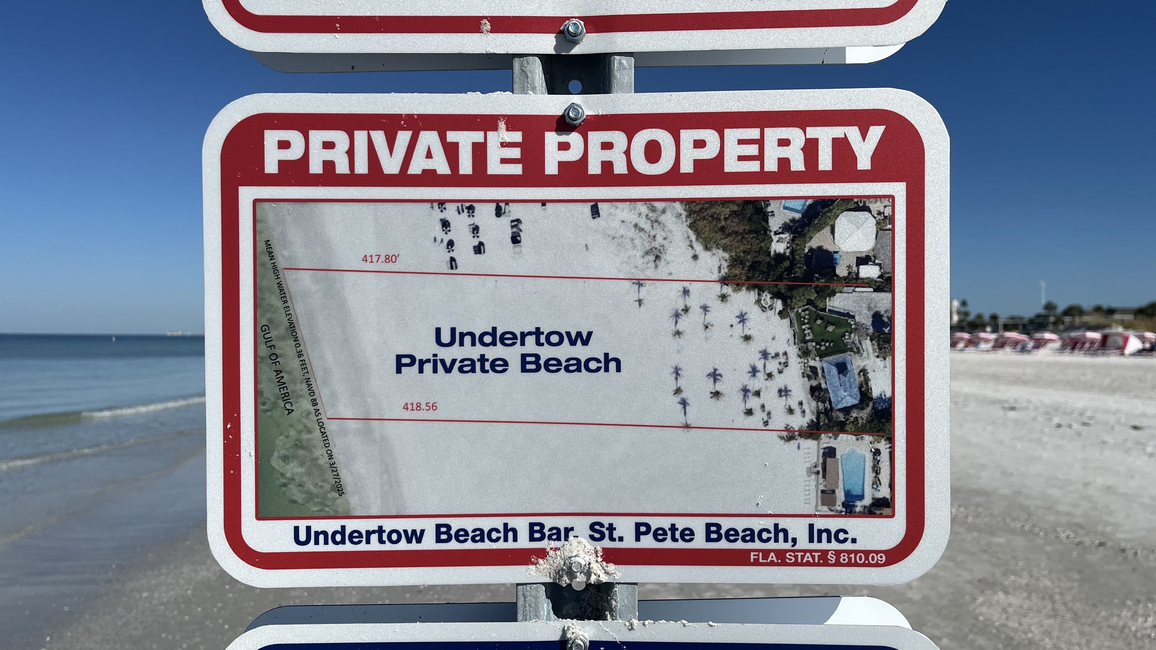 Red and white "Private Property" sign showing a map of Undertow Private Beach with measurements, located at Undertow Beach Bar, St. Pete Beach, Florida, with the Gulf of America on the left.