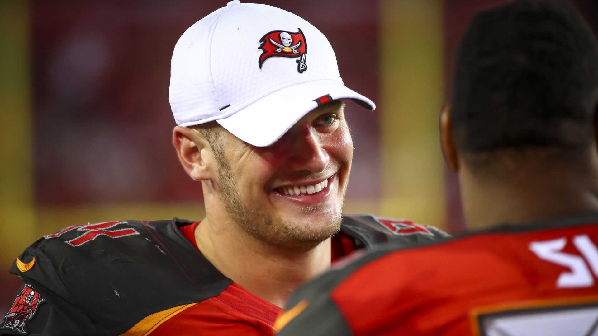 Carl Nassib wearing a Bucs hat