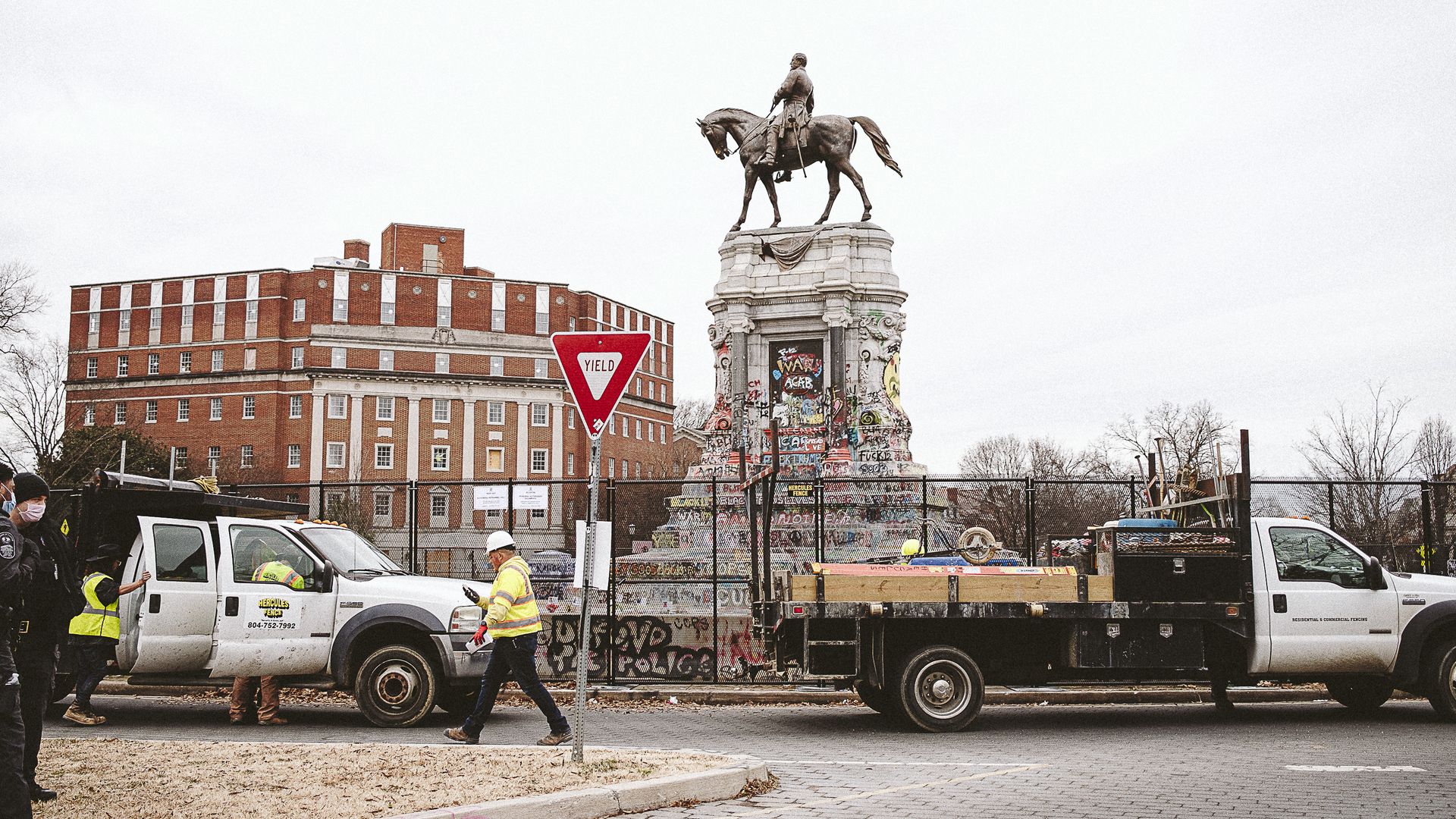 Workers install an 8-foot fence around the Robert E. Lee monument on January 25, 2021 in Richmond, Virginia. 