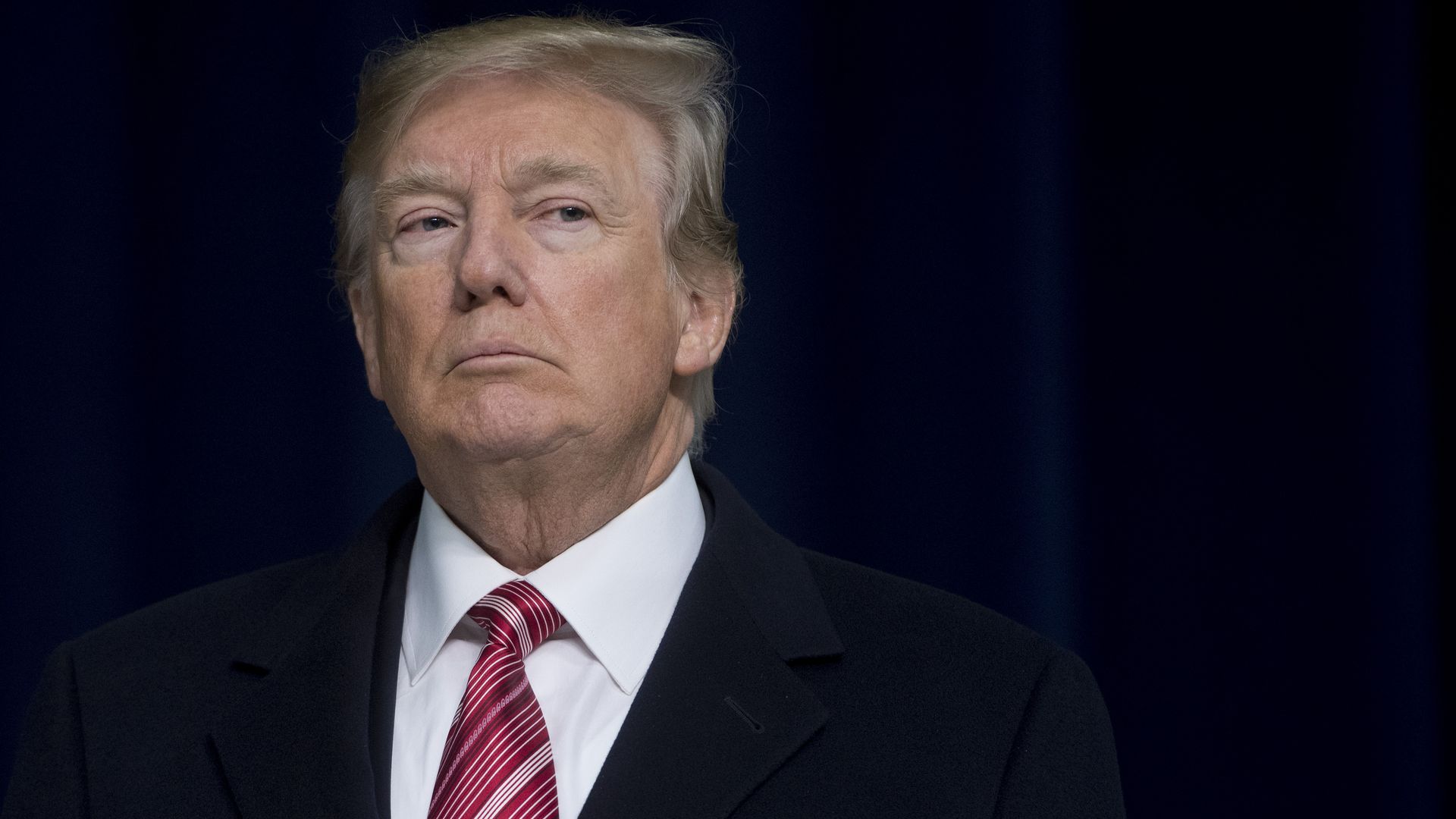 President Trump looks off into the distance.