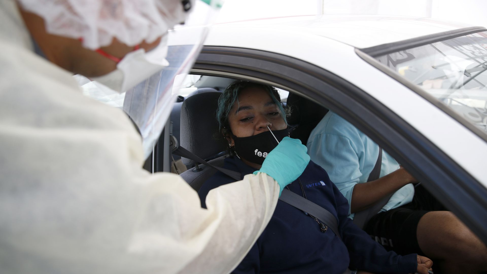  Dr. Faiz Ansari gives Emani Vaughn a COVID-19 test at the Clínica de La Raza testing site along East 12th Street and Derby Avenue in Oakland, Calif., 