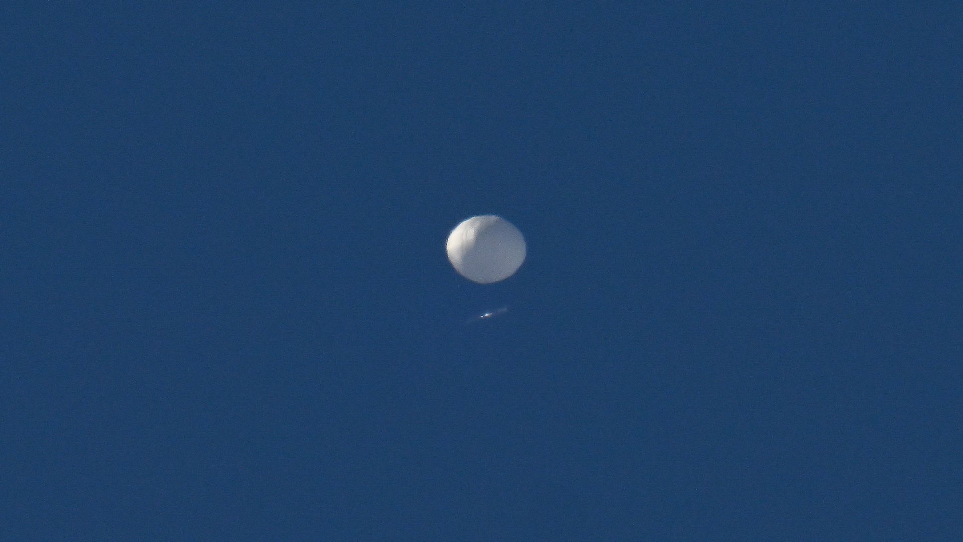 The weather balloon against a blue sky