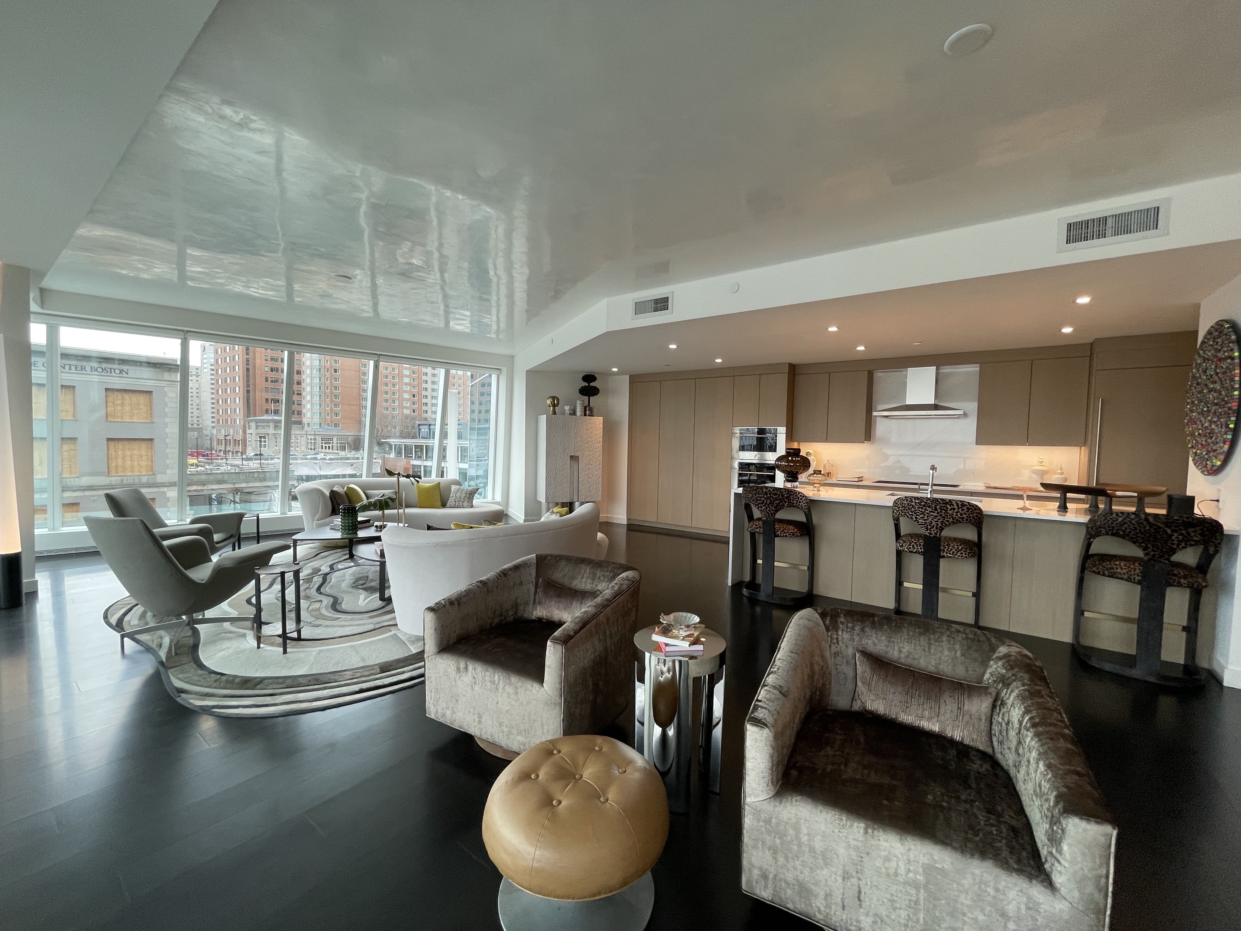 A living room and kitchen area inside a 3 bed, 3.5 bath condo at the St. Regis residences.