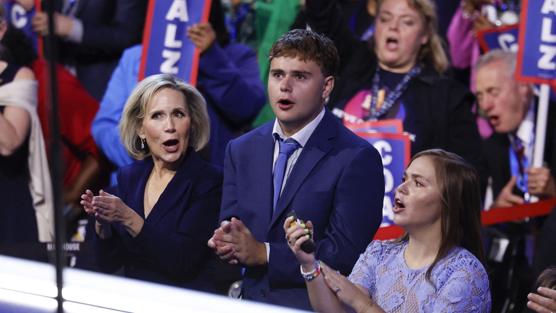 Gwen Walz claps next to her kids 