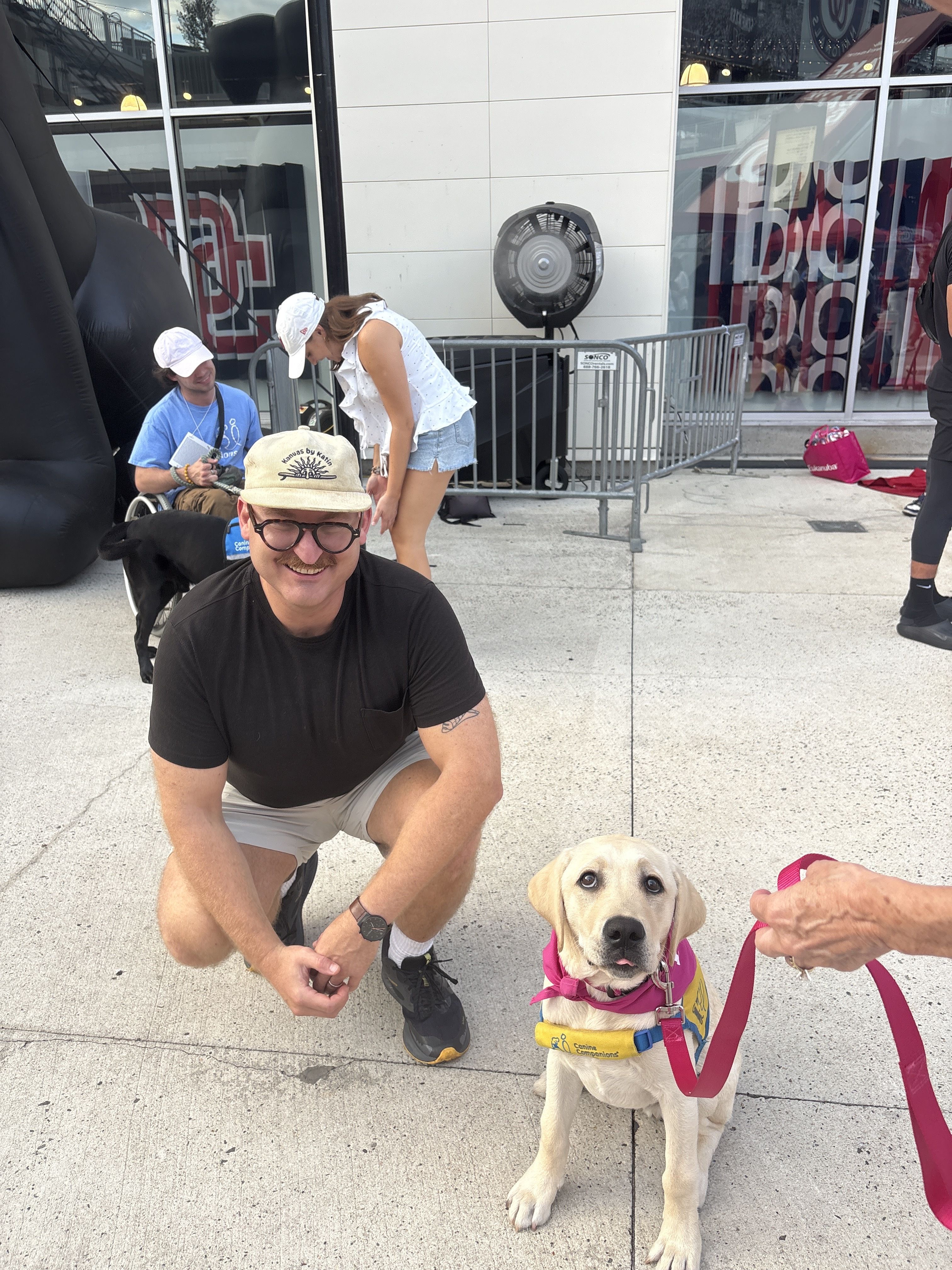 The author crouches down to pose with Natty the team dog.