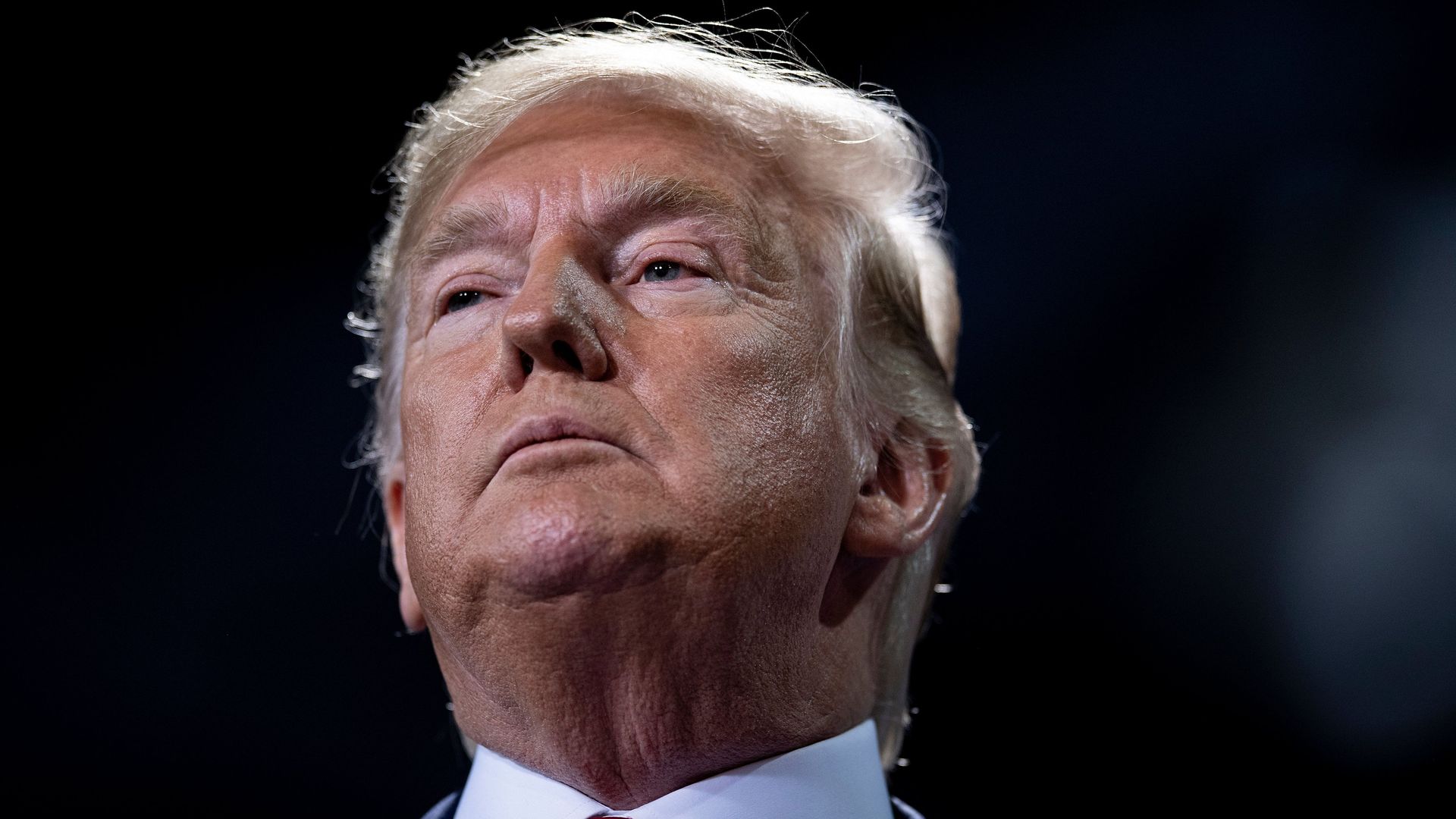 President Donald Trump looks on from the stage during a Keep America Great Rally at Kellogg Arena December 18, 2019, in Battle Creek, Michigan