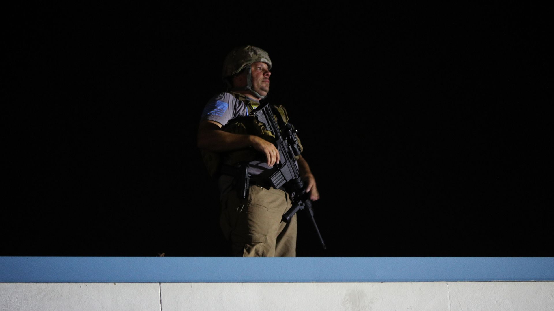Photo of man in the night with helmet and rifle