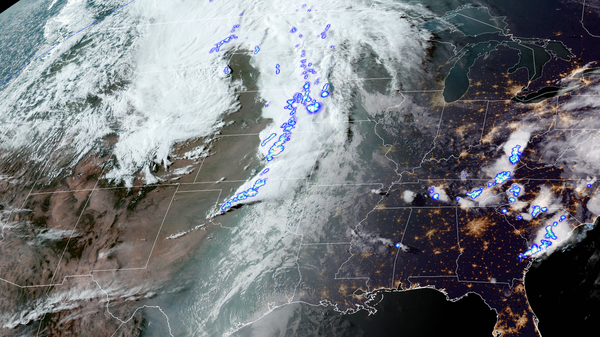 Satellite image showing severe thunderstorms underway across the Plains on Monday night, with flashes of lightning within each storm.