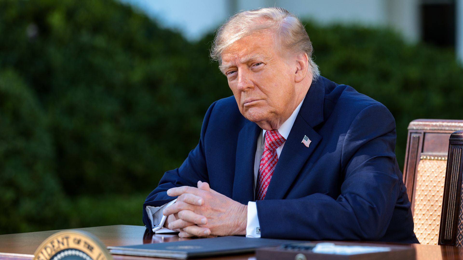 U.S. President Donald Trump listens as first lady Melania Trump delivers remarks as he prepares to sign an executive order in the Rose Garden of the White House on October 19, 2026 in Washington, DC. 