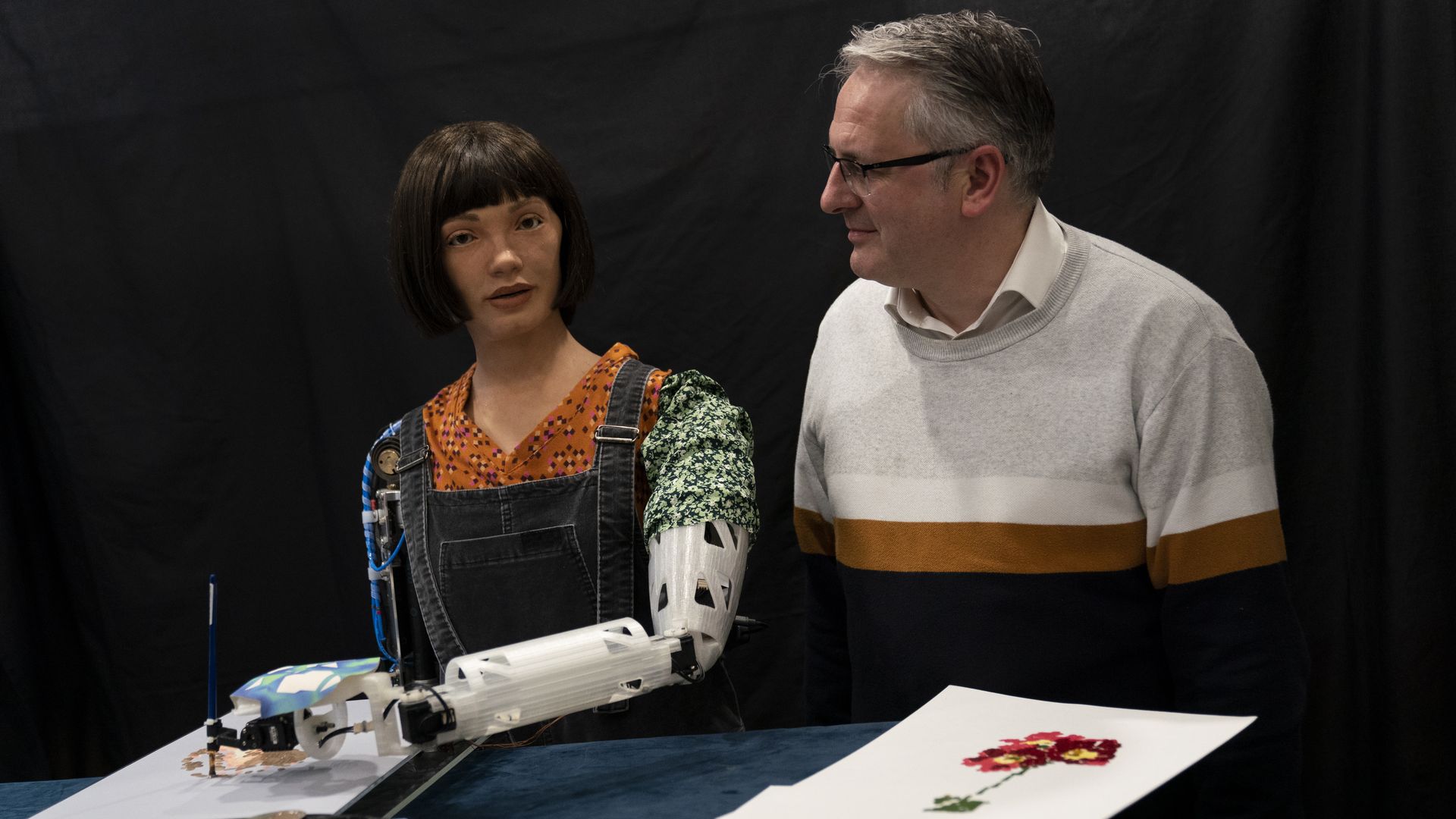Ai-Da, a robot who paints,  with her creator Aidan Meller. 