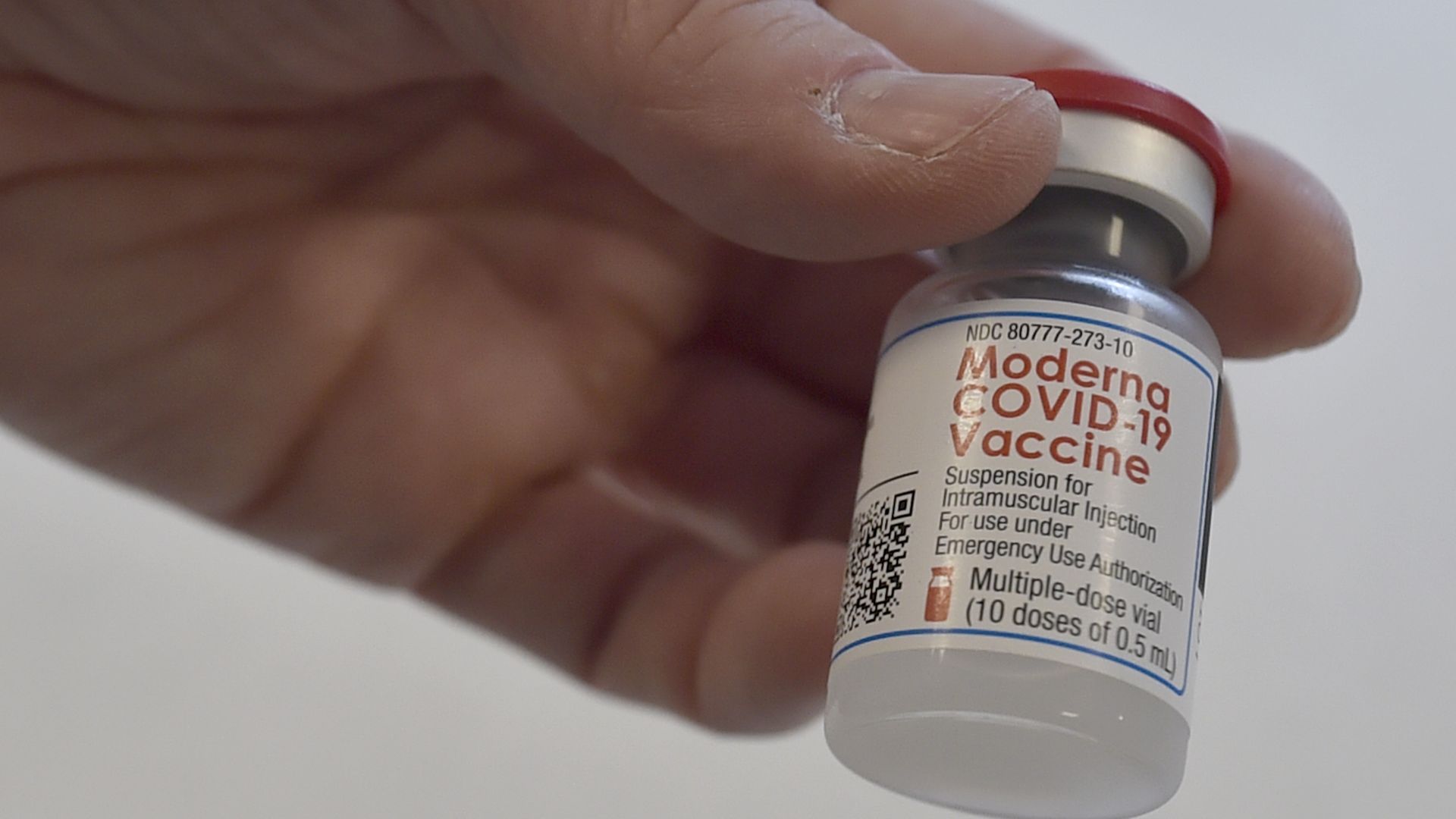 A health workers holds a vial of containing Moderna Covid-19 vaccine 