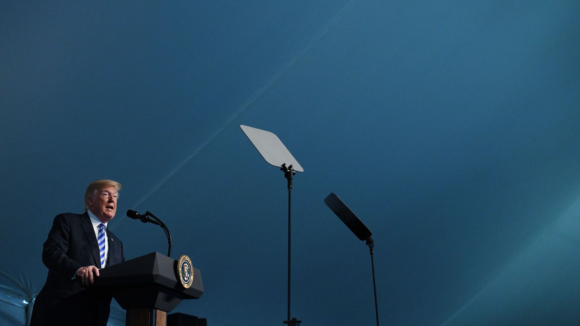 President Trump speaking at a podium.