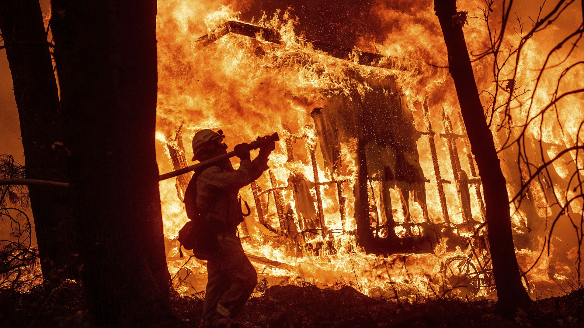 A firefighter attempts to battle a raging California wildfire