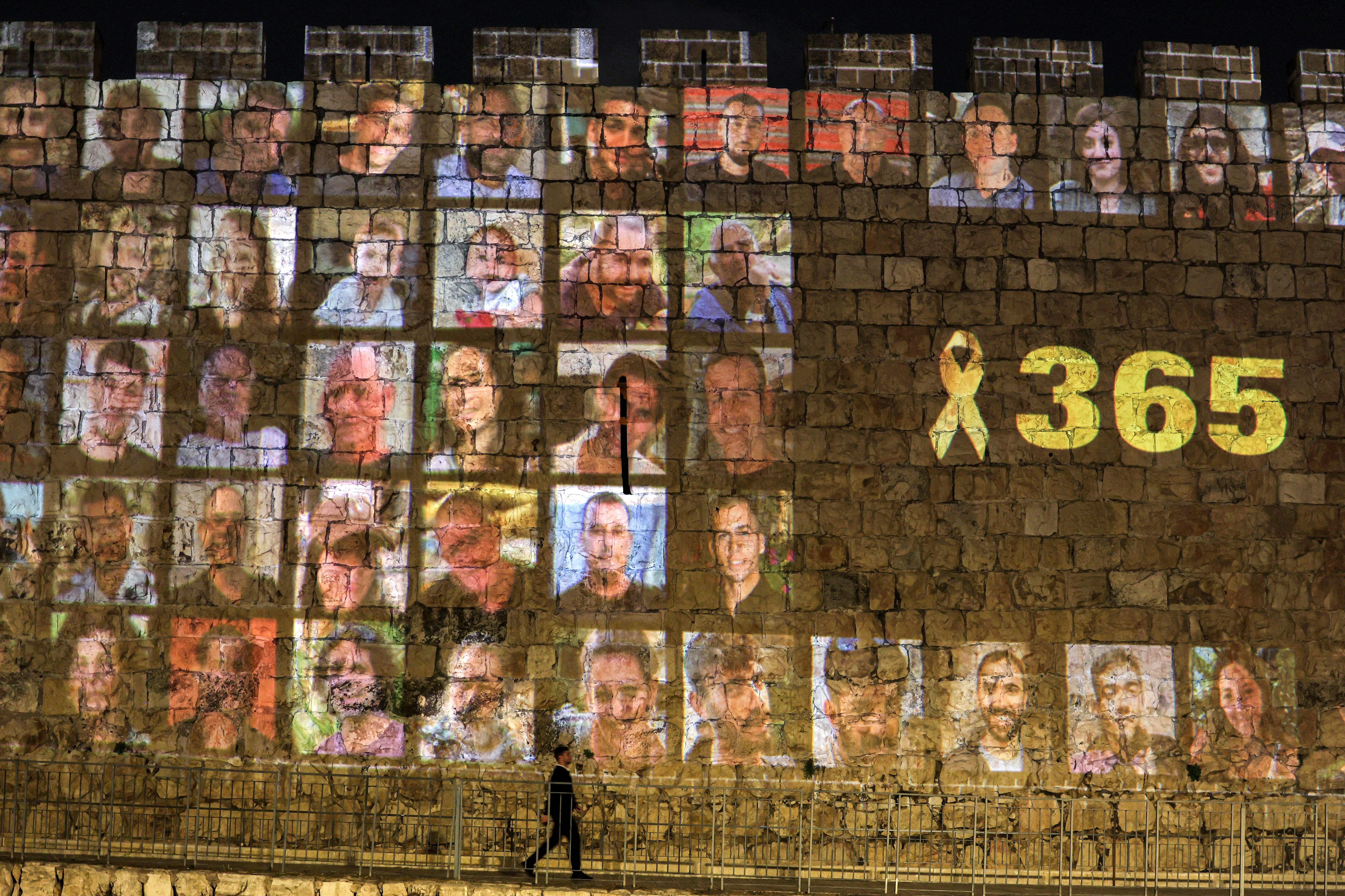Pictures of hostages kidnapped on Oct. 7 are projected onto a wall in the Old City of Jerusalem.