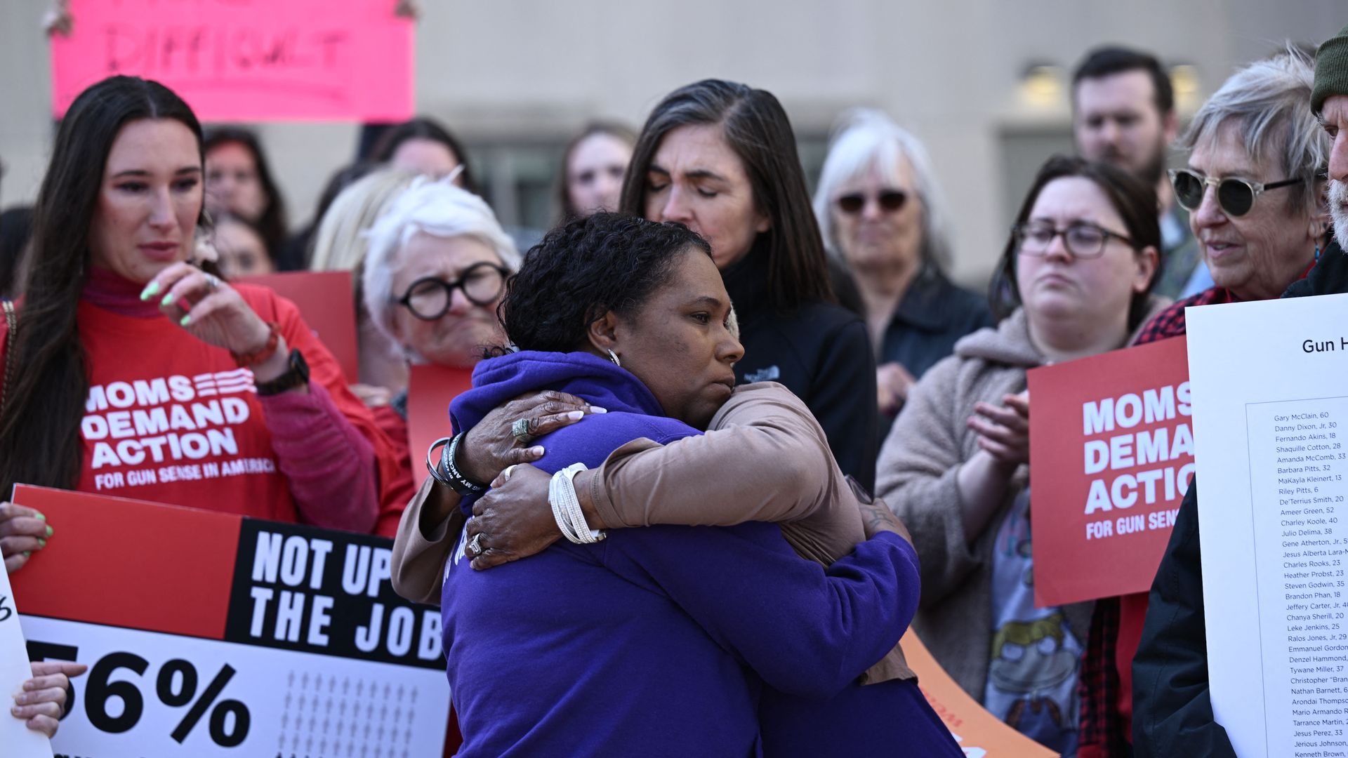 Gun control activists hug at a rally in Nashville.