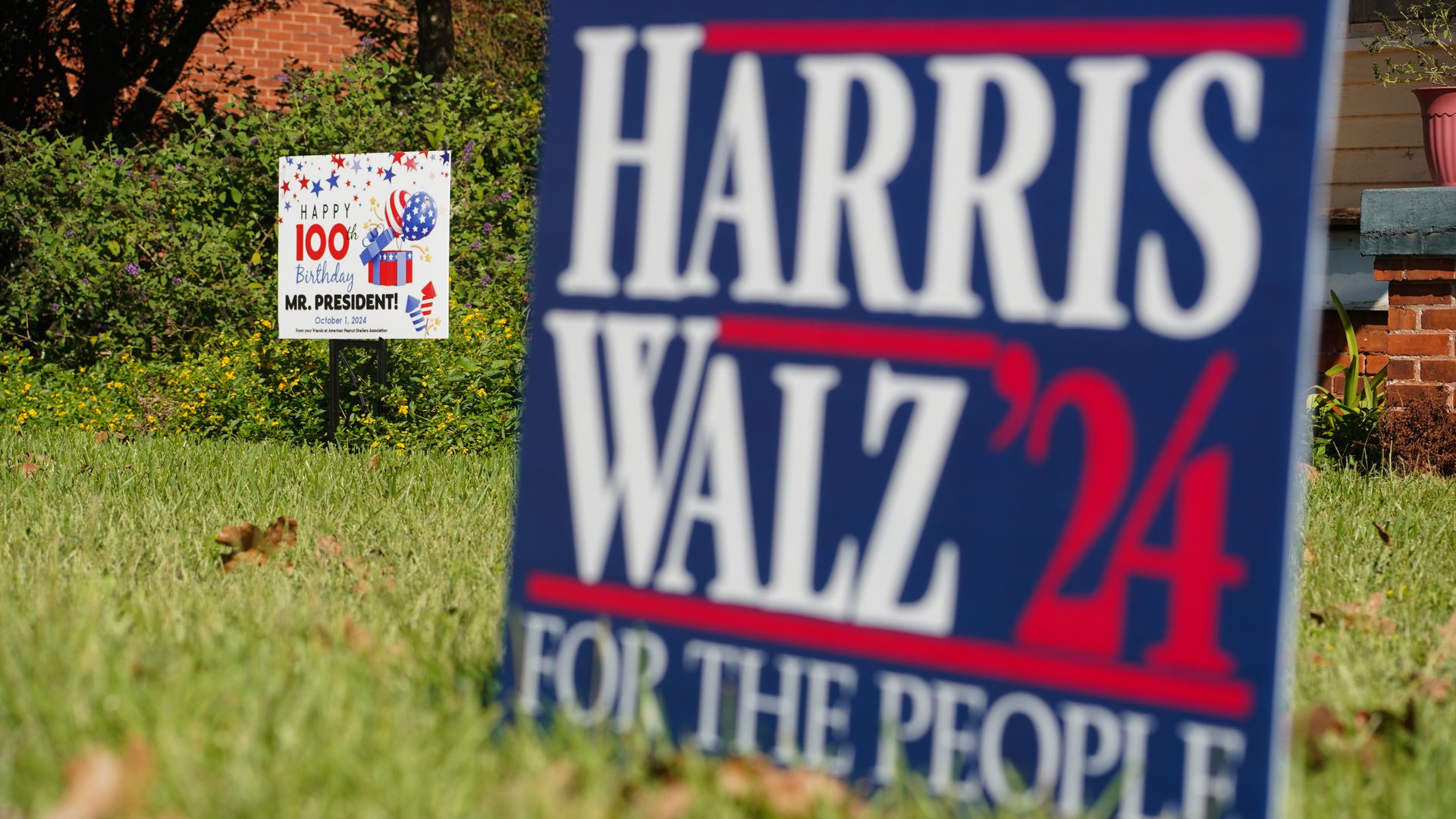 Jimmy Carter and Harris/Walz yard signs