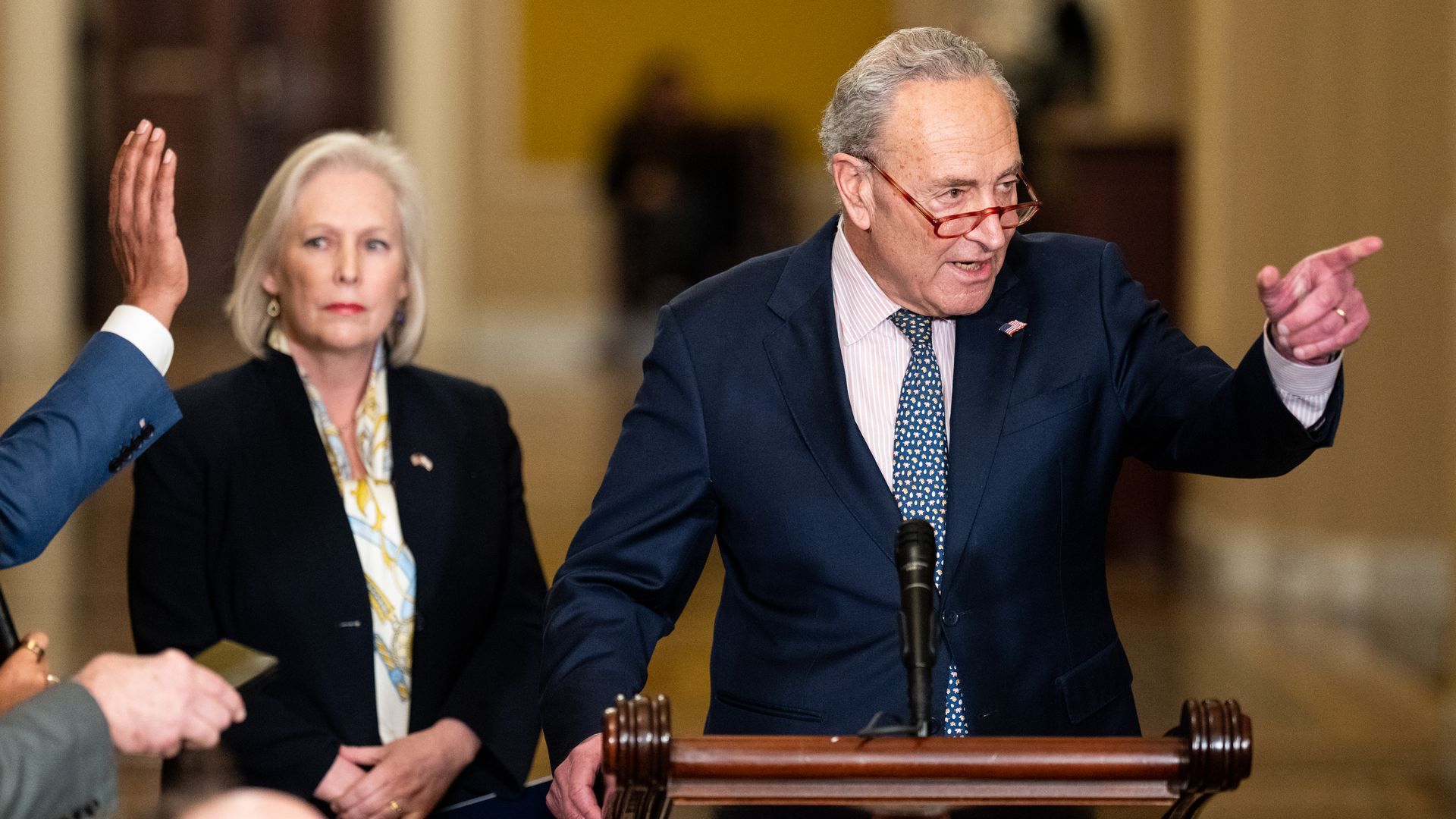 Senate Majority Leader Chuck Schumer, D-N.Y., calls on a reporter as Sen. Kirsten Gillibrand, D-N.Y., looks on during the Senate Democrats' news conference in the Capitol on Tuesday, October 31, 2023.